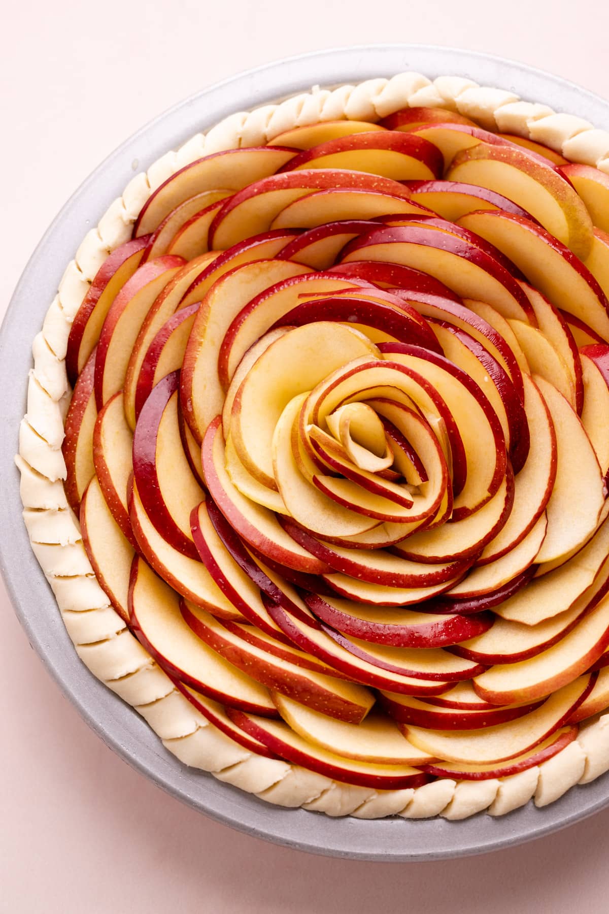 An unbaked apple rose pie.