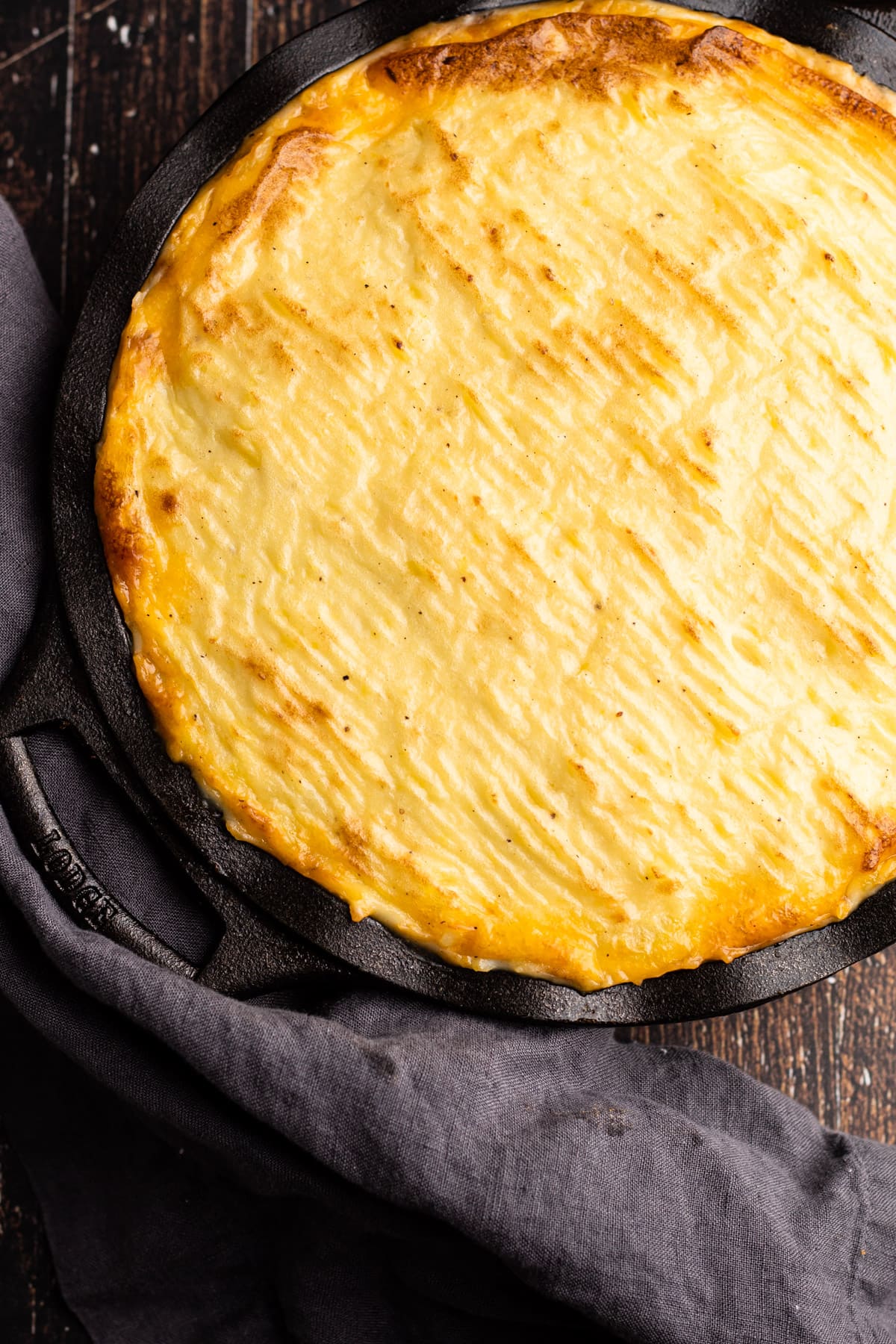 A fully baked shepherd's pie made with beef in cast iron pie plate.