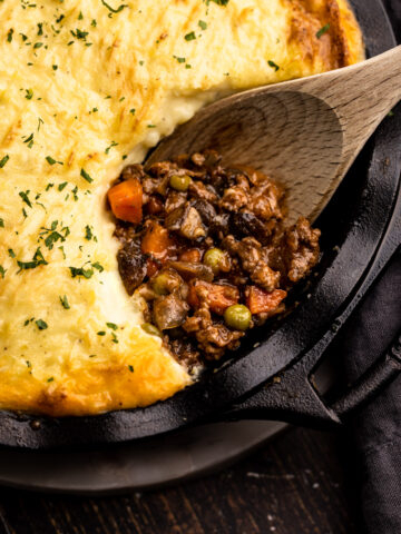 Beef shepherd's pie with a portion removed to reveal the savory beef filling.