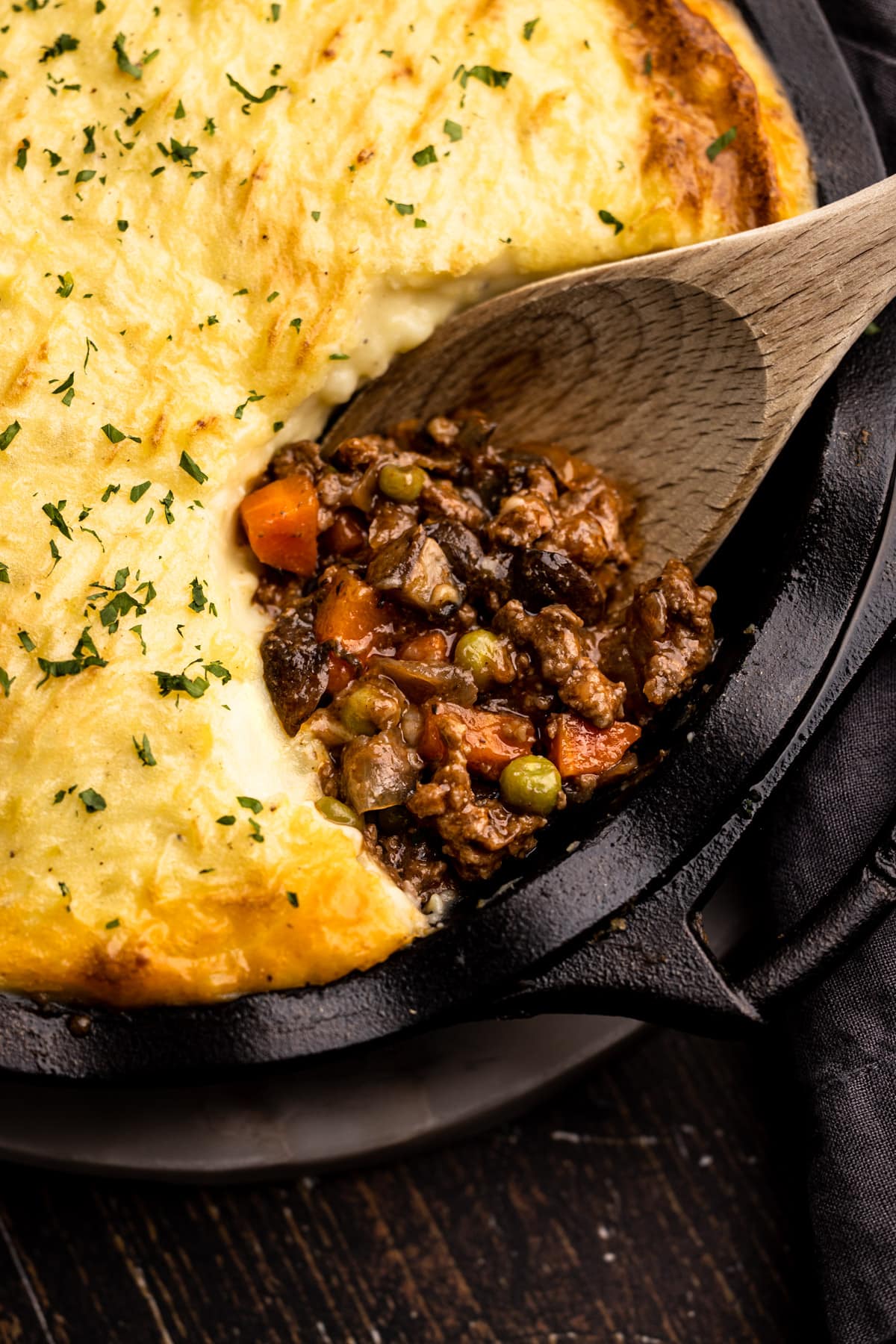 Beef shepherd's pie with a portion removed to reveal the savory beef filling.