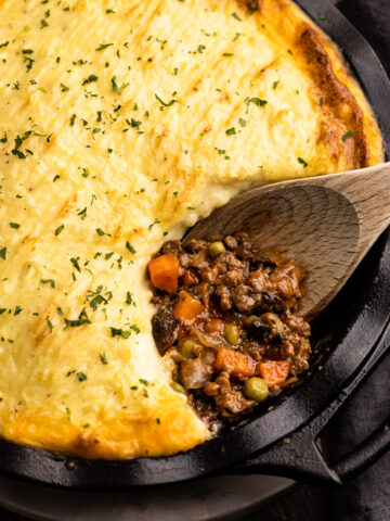 Beef shepherd's pie with a portion removed to reveal the savory beef filling.