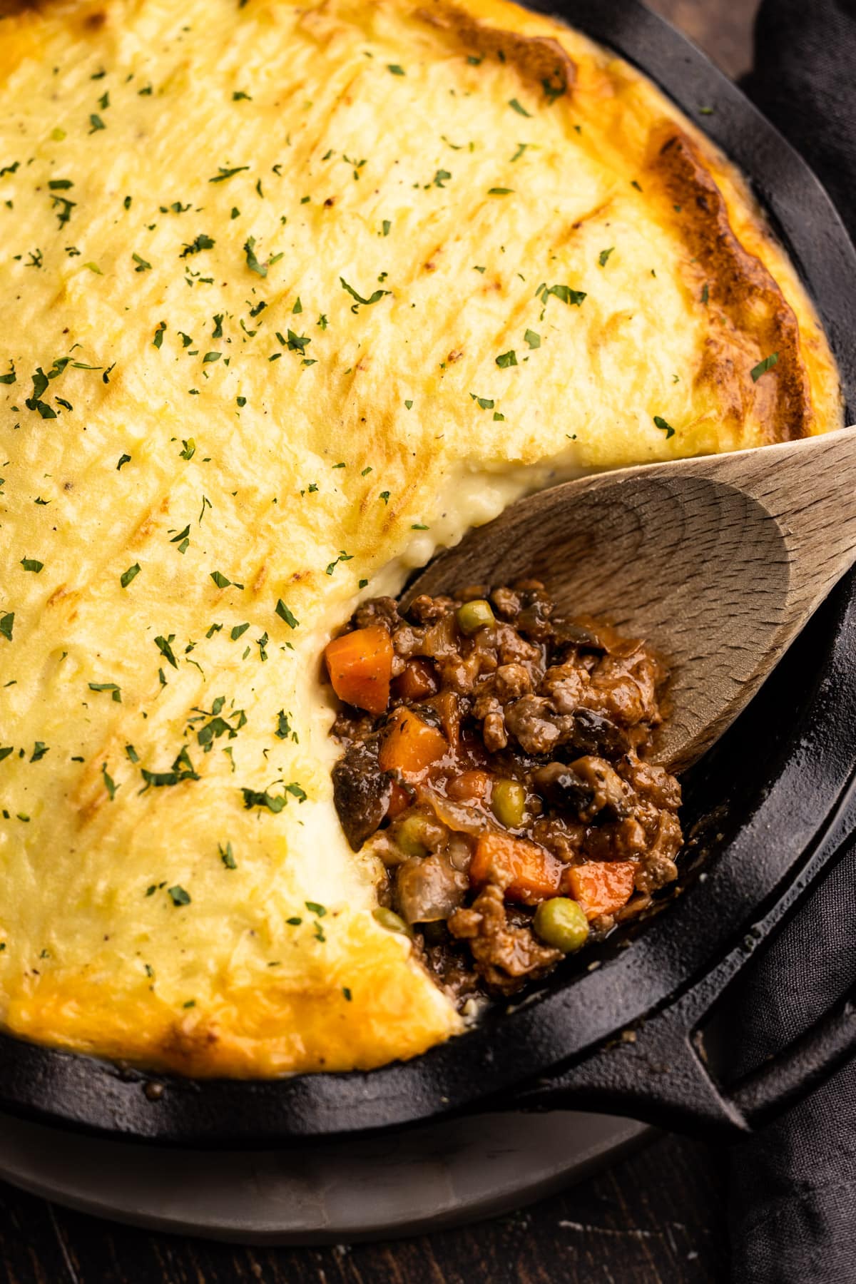 Beef shepherd's pie with a portion removed to reveal the savory beef filling.