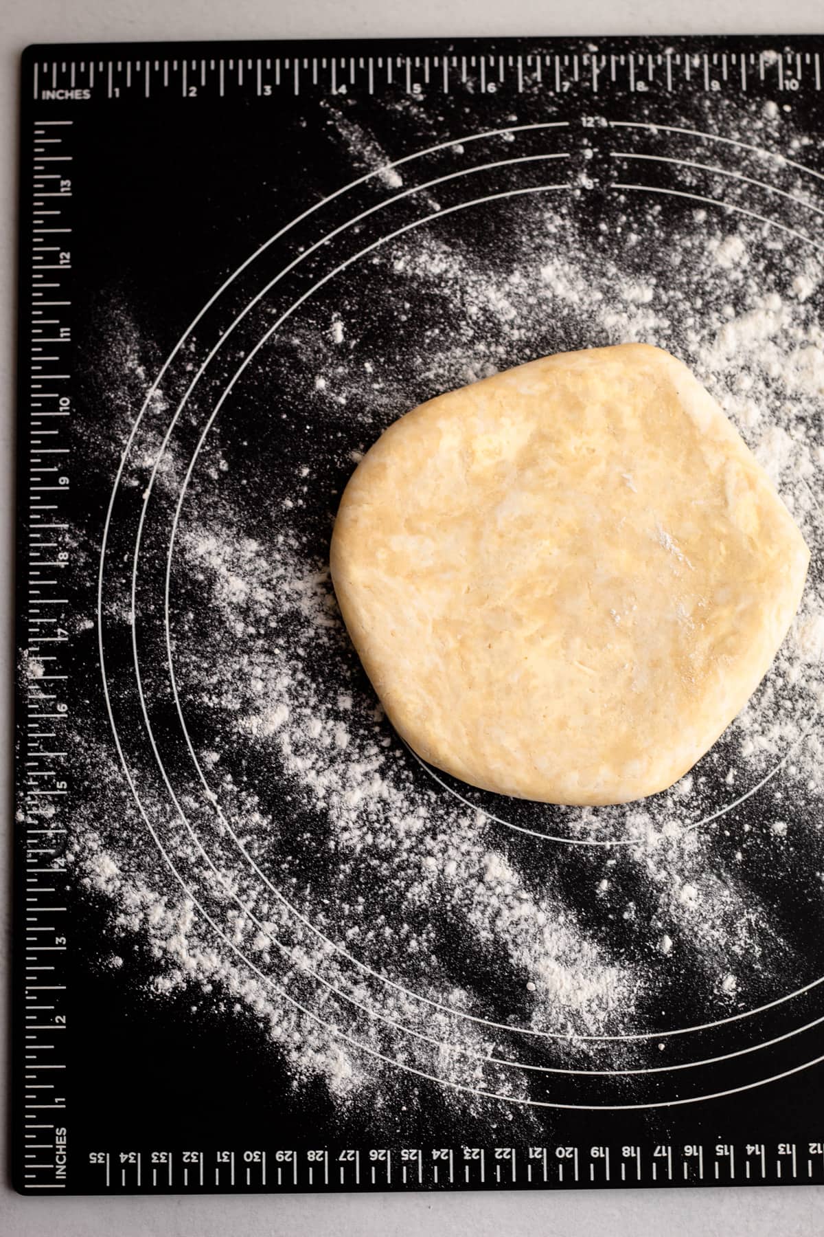A sour cream pie crust on a pastry board.