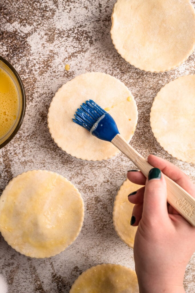 Individual beef pot pies being assembled.