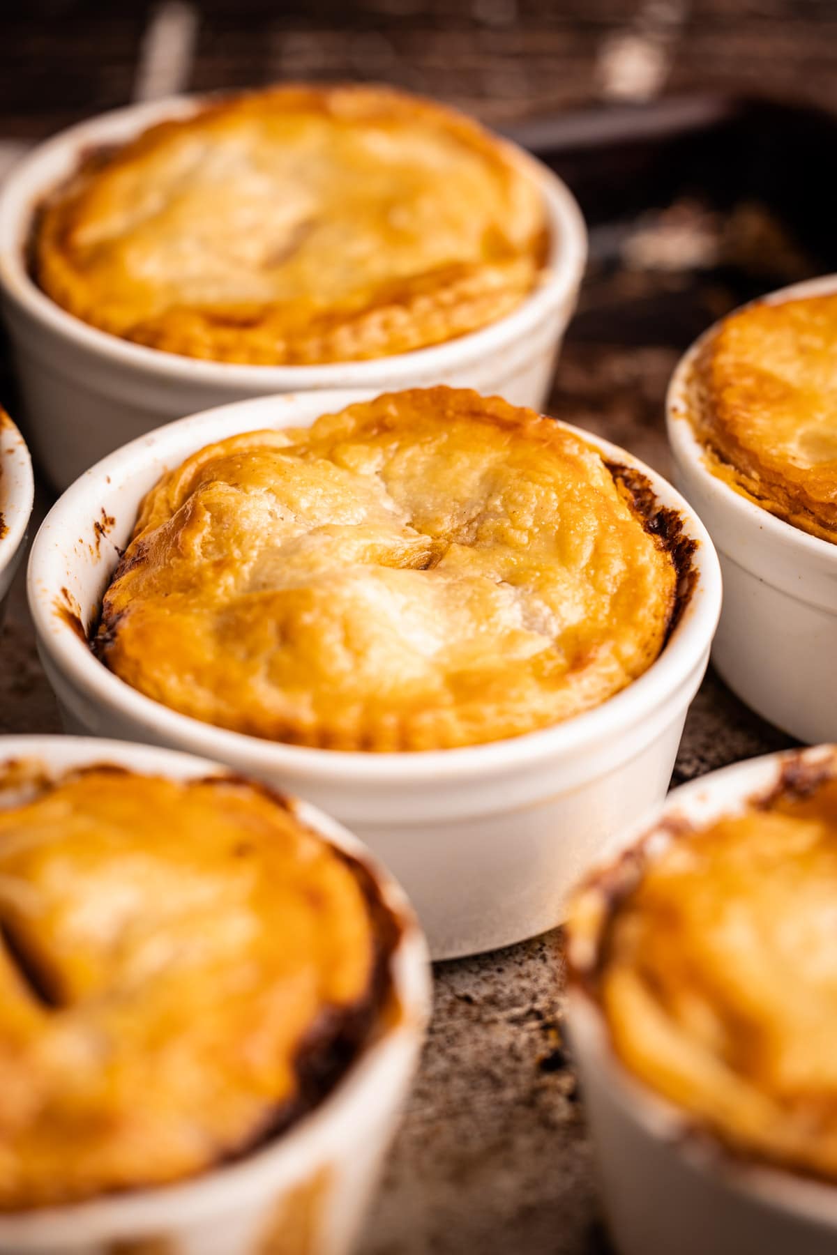 Six baked beef pot pies.