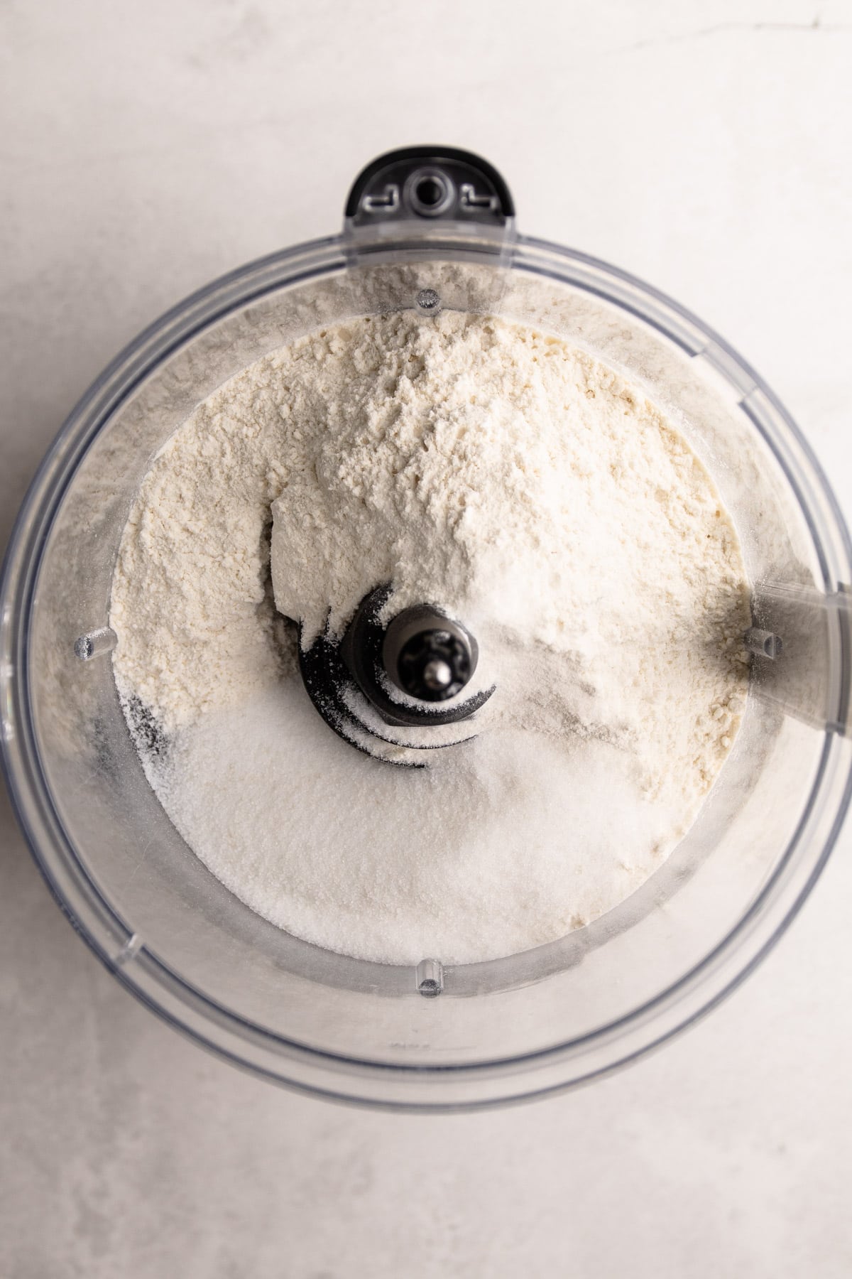 Ingredients in a food processor for pie crust.