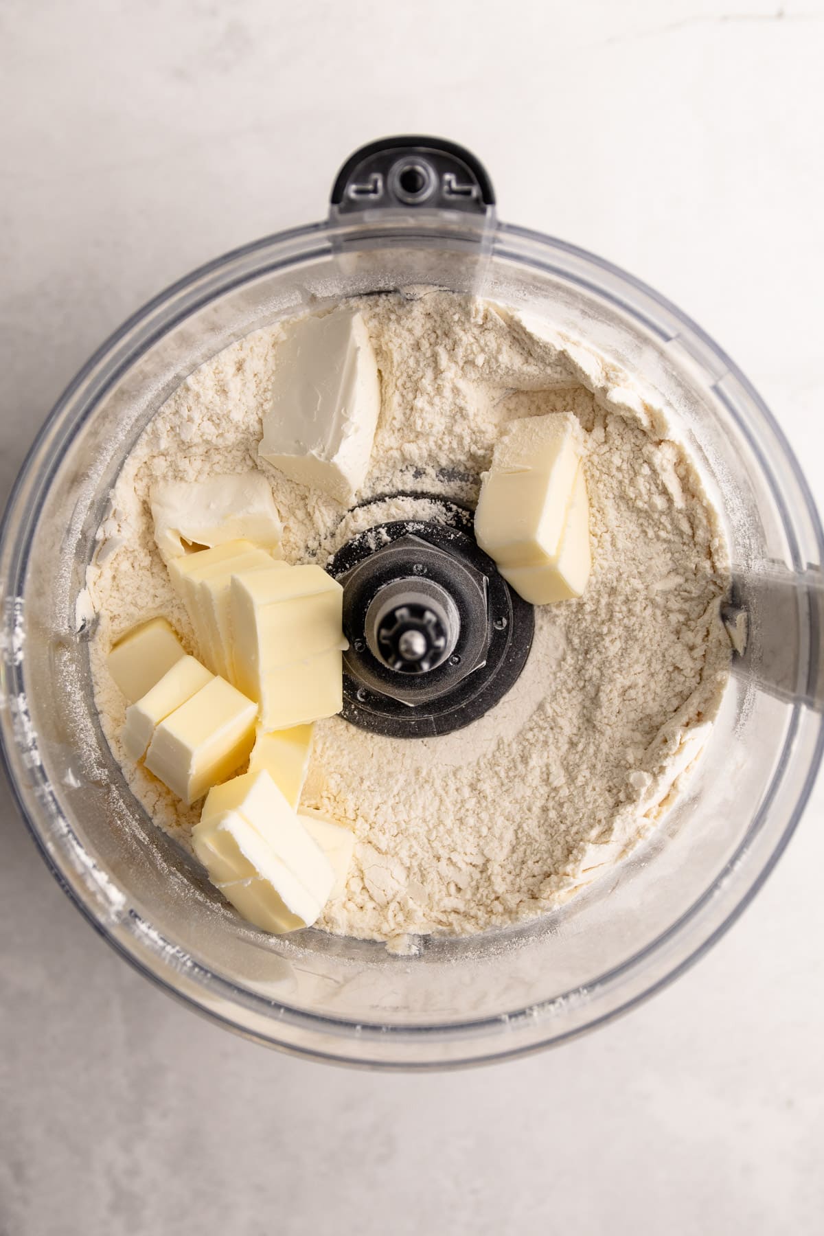 Ingredients in a food processor for pie crust.