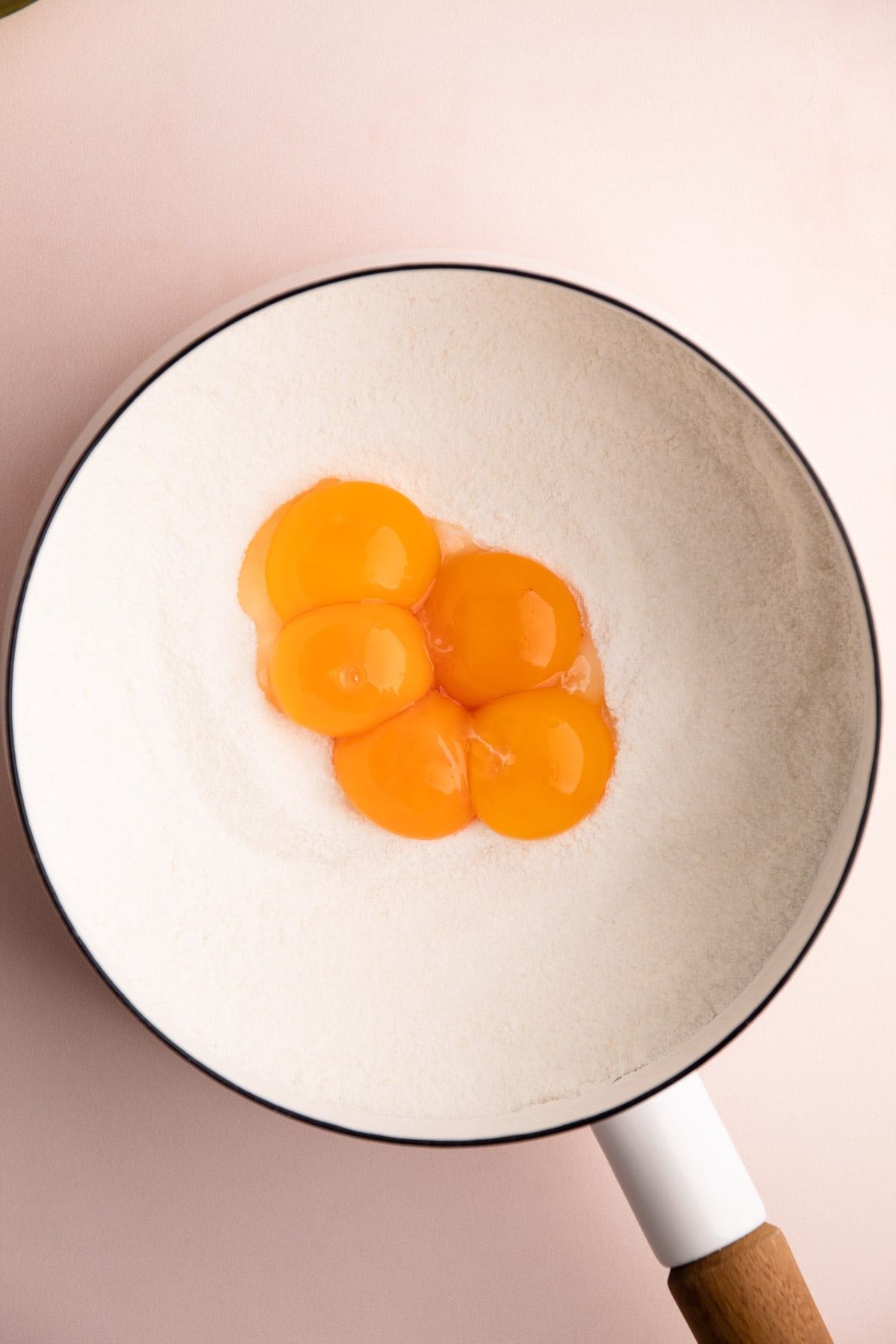 Egg yolks in a pot with sugar.