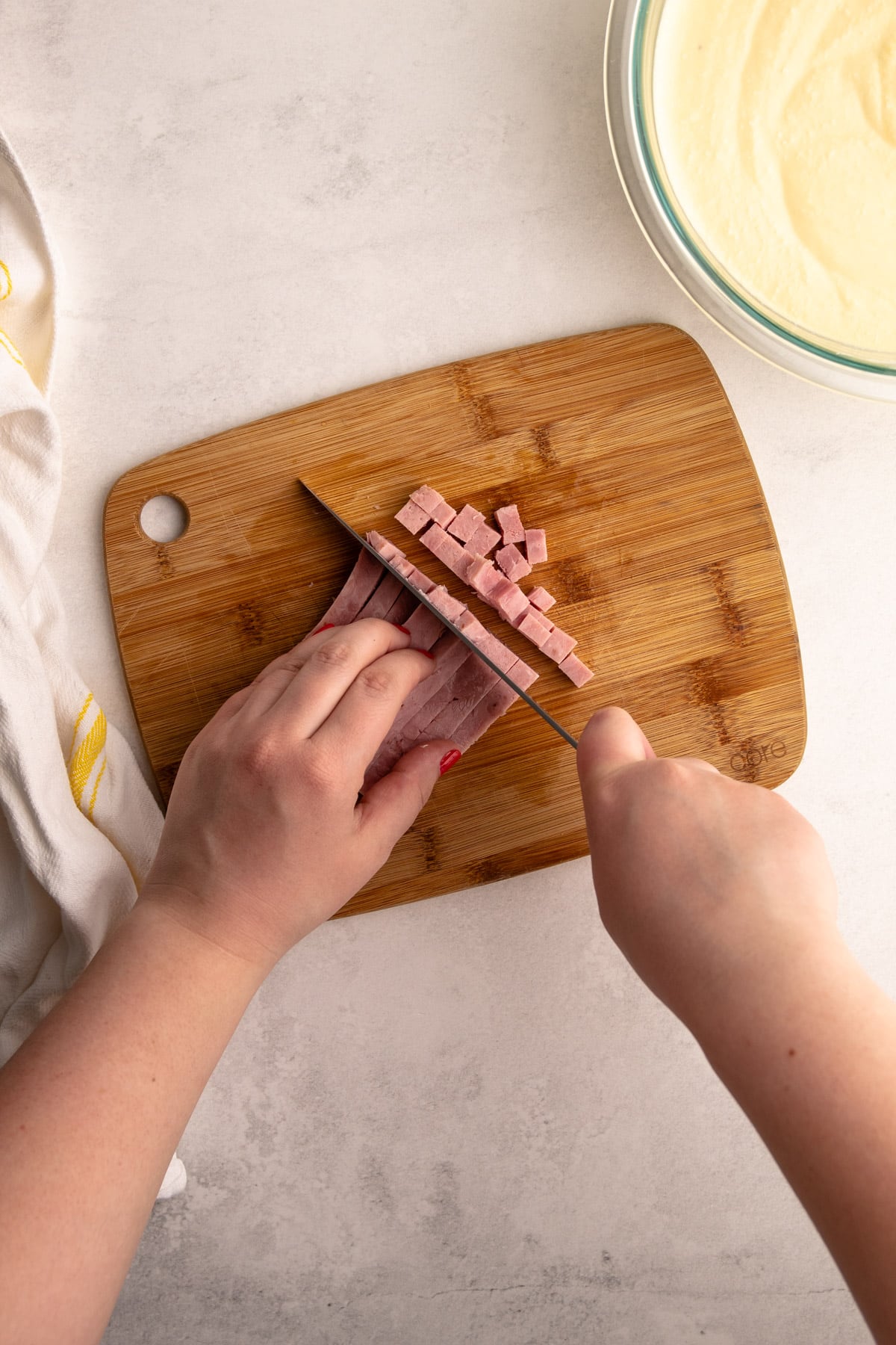 Cutting deli meat for pizza rustica.