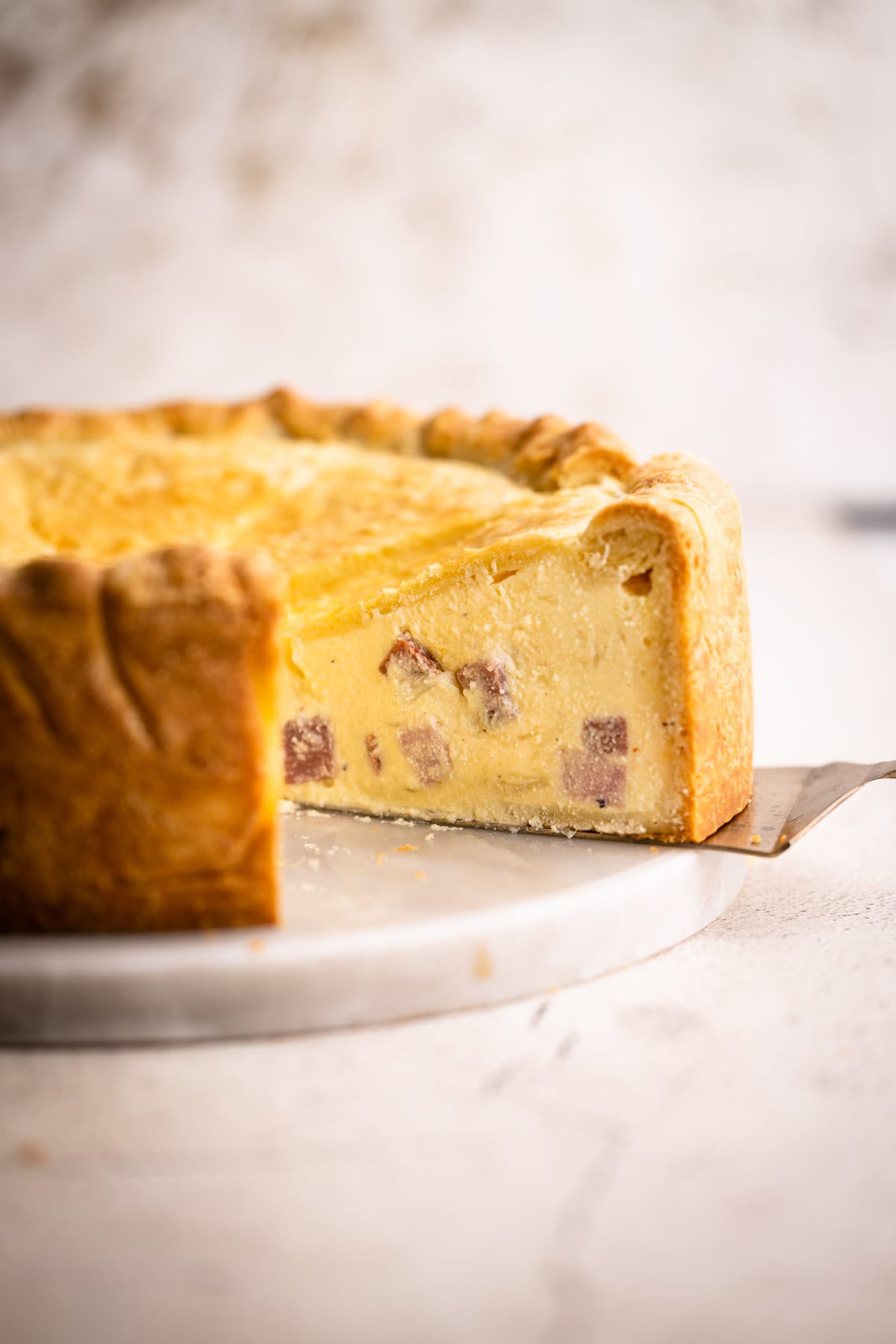 Pizza rustica with a slice being removed.