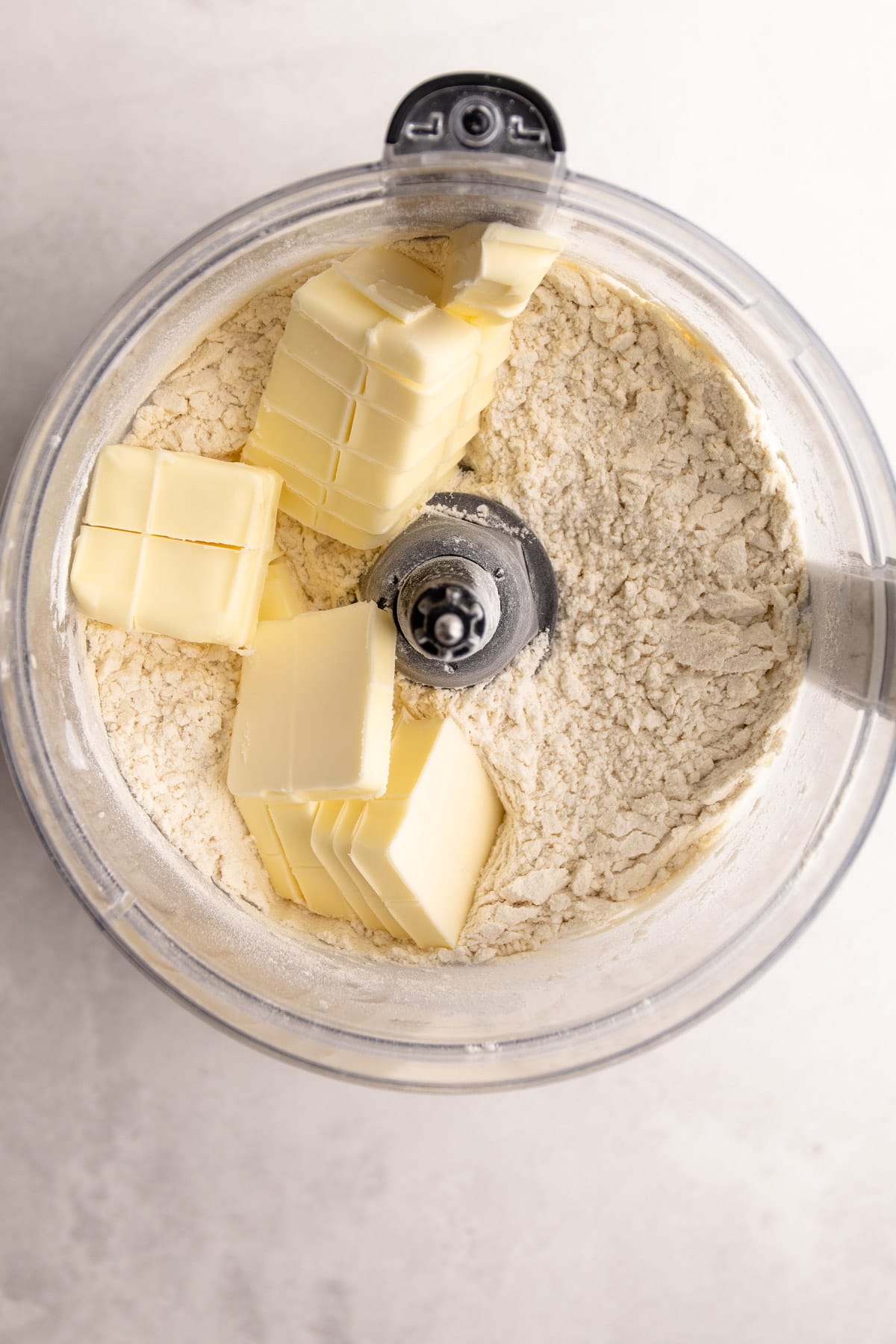 Ingredients in a food processor to make italian pie pastry.