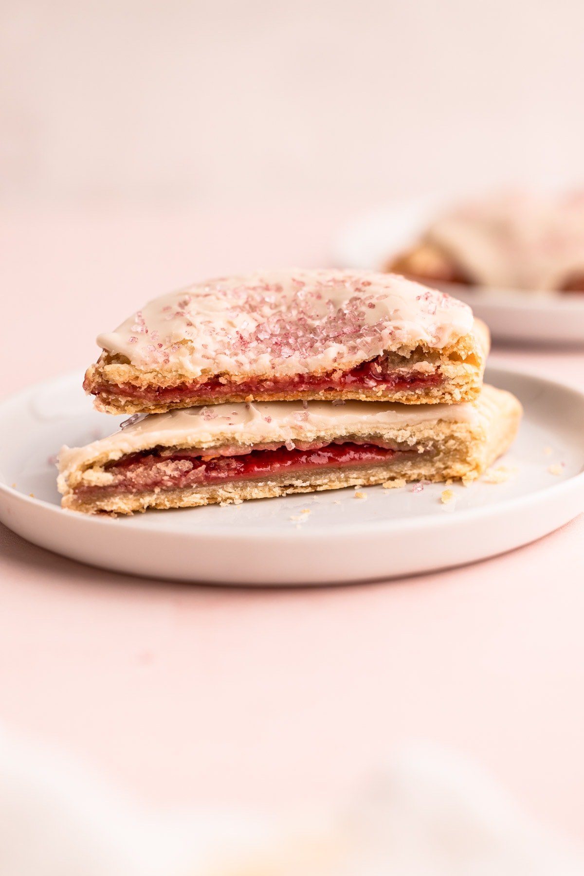 Strawberry pop tarts cut open on a plate.