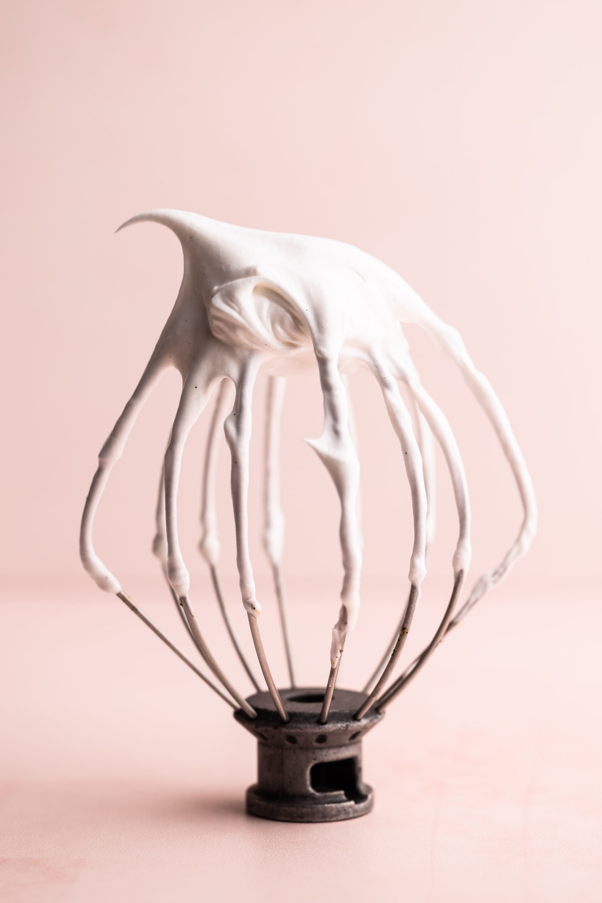 Swiss meringue on a stand mixer whisk.