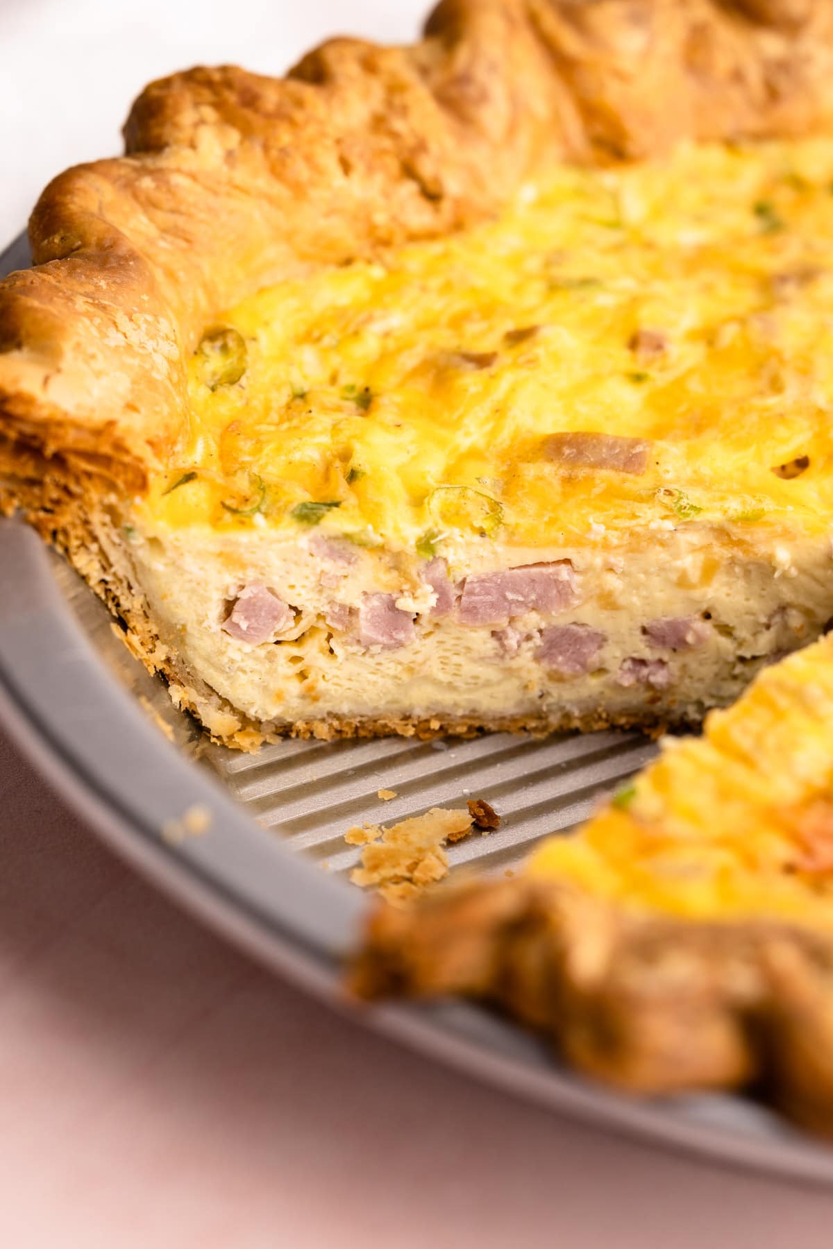 A sliced ham and cheese quiche.