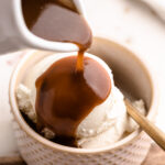 Homemade butterscotch sauce being poured over ice cream.