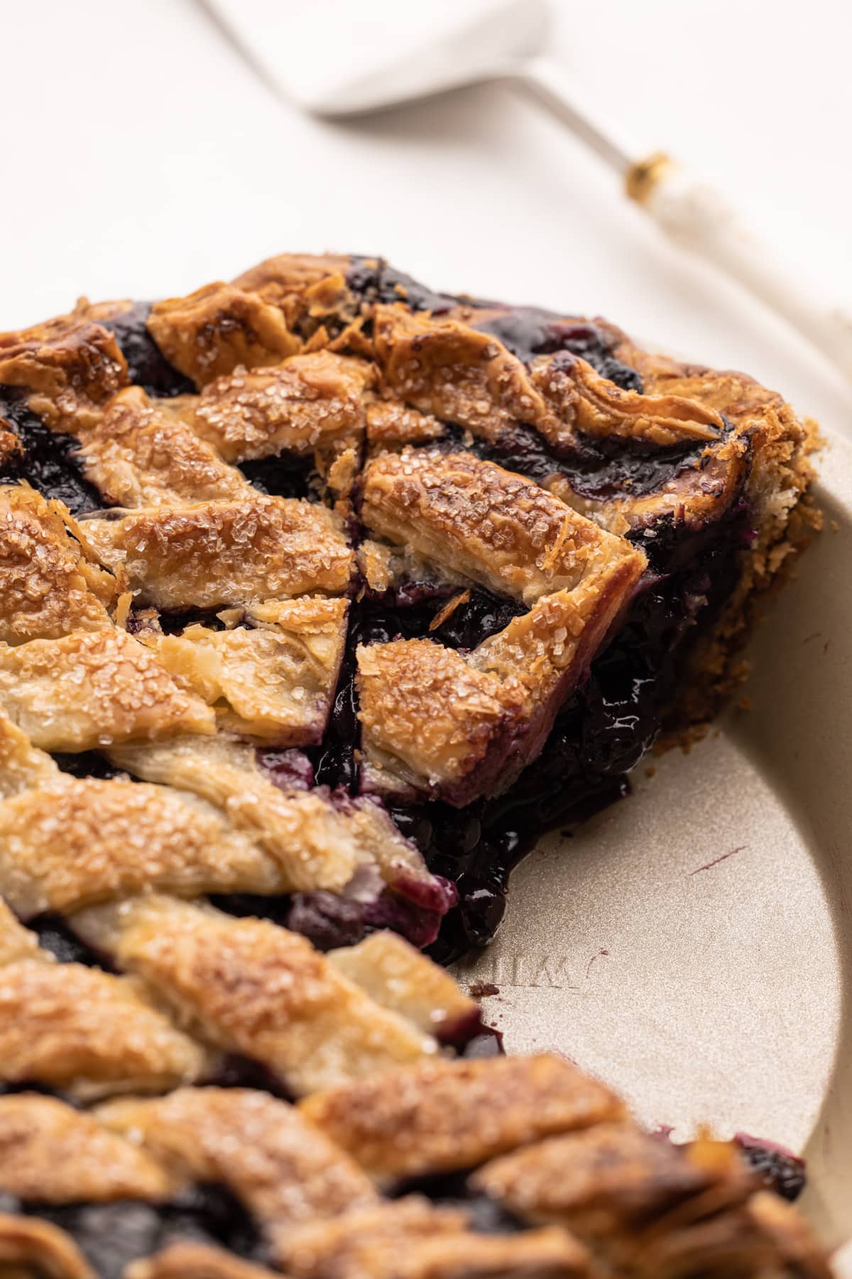 Classic blueberry pie with a slice removed.