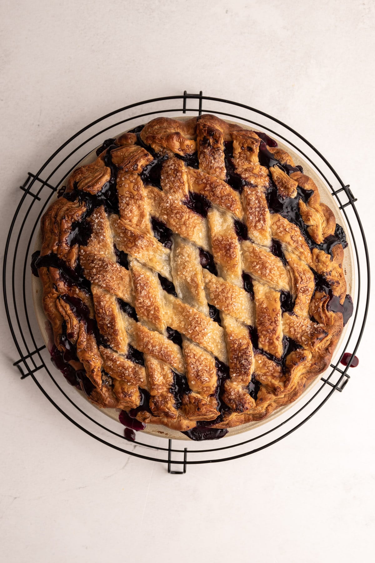 A fully baked blueberry pie made with a butter pie crust.