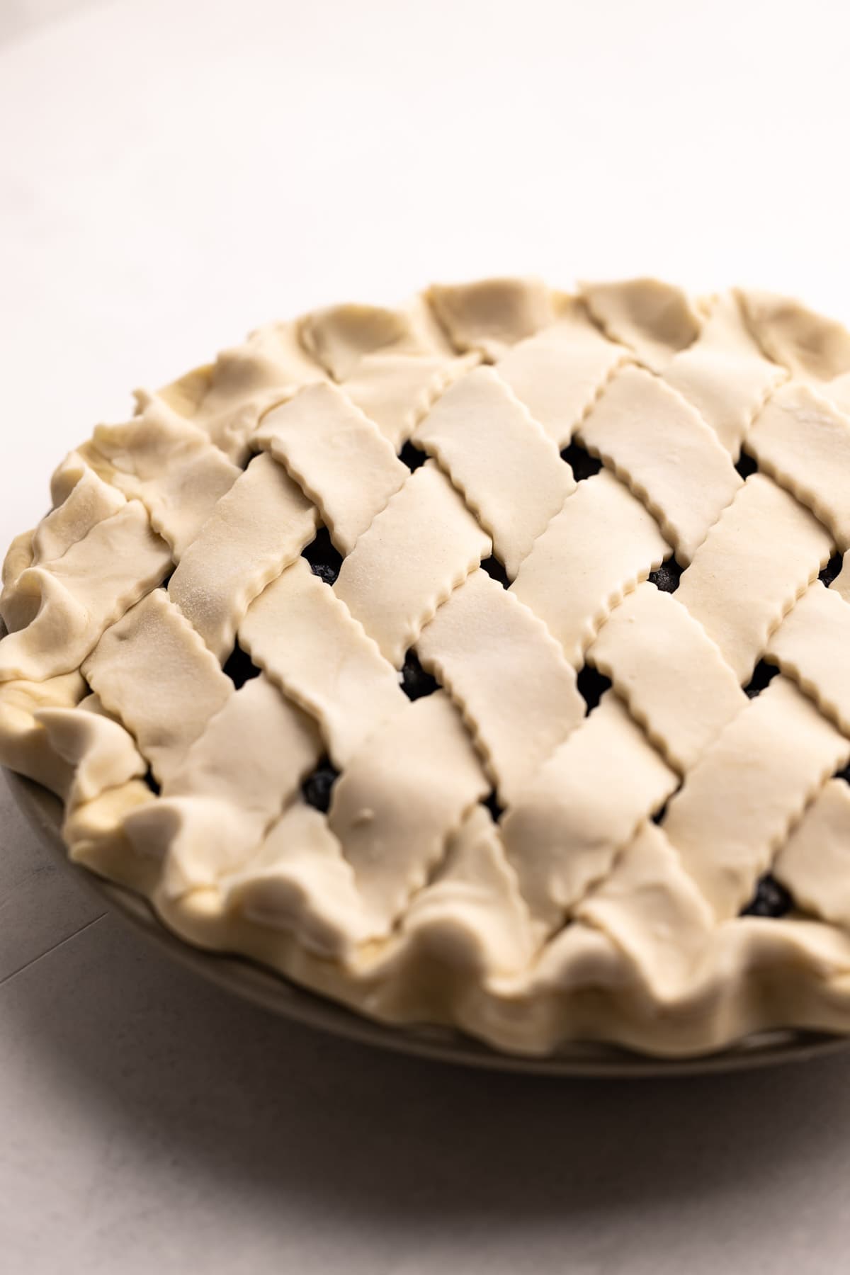 A lattice blueberry pie made with butter pie crust.