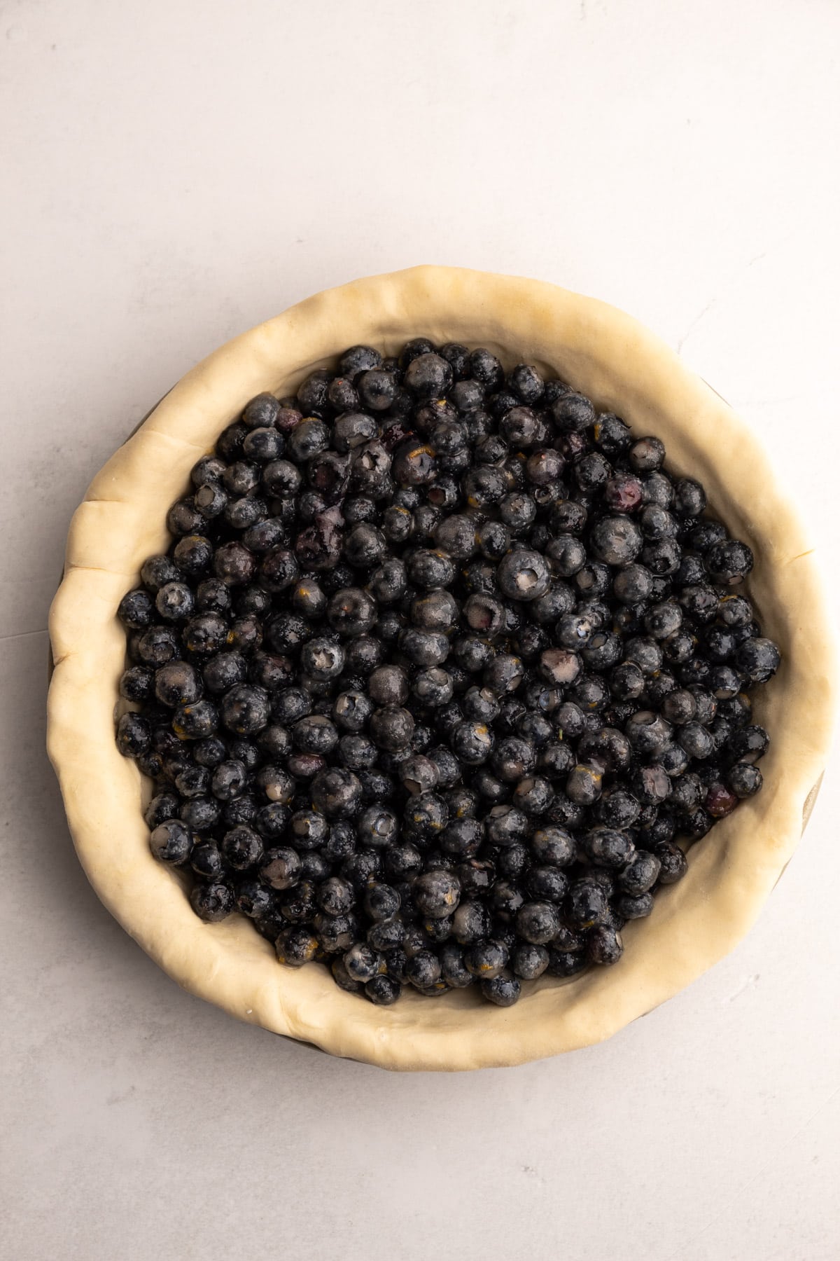 Blueberry pie filling in an unbaked pie crust.