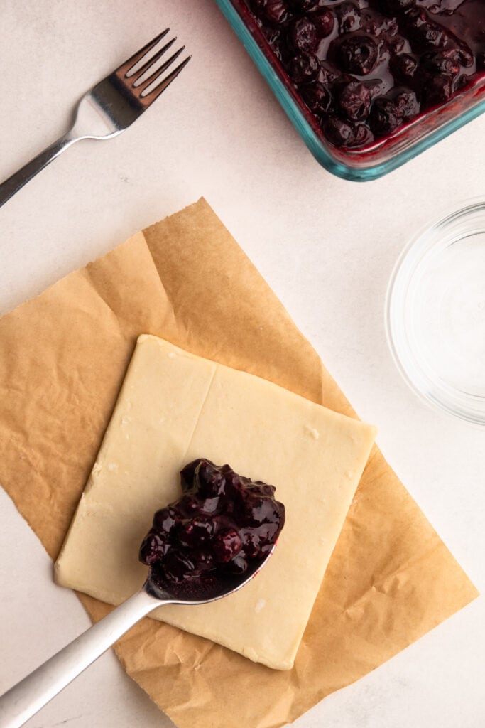 A blueberry turnover being filled.