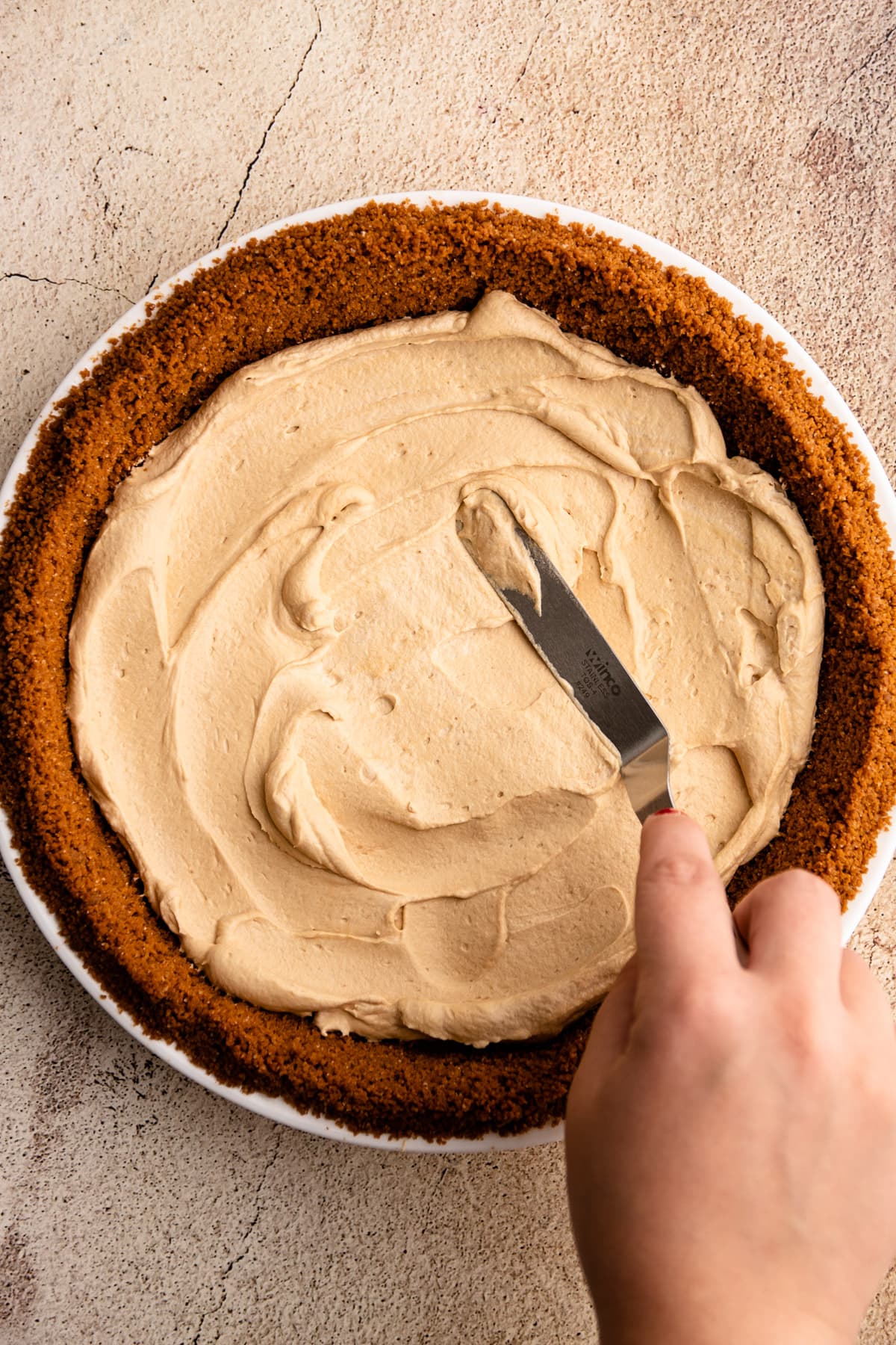 Assembling a no bake coffee pie.