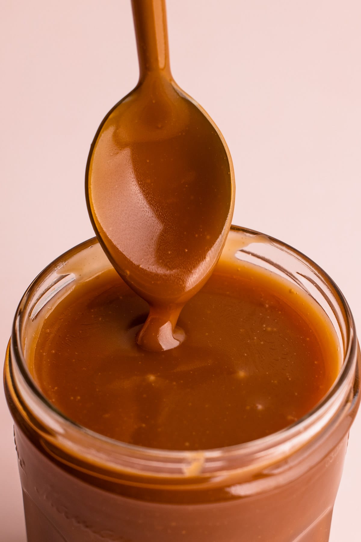Caramel dripping off of a spoon.