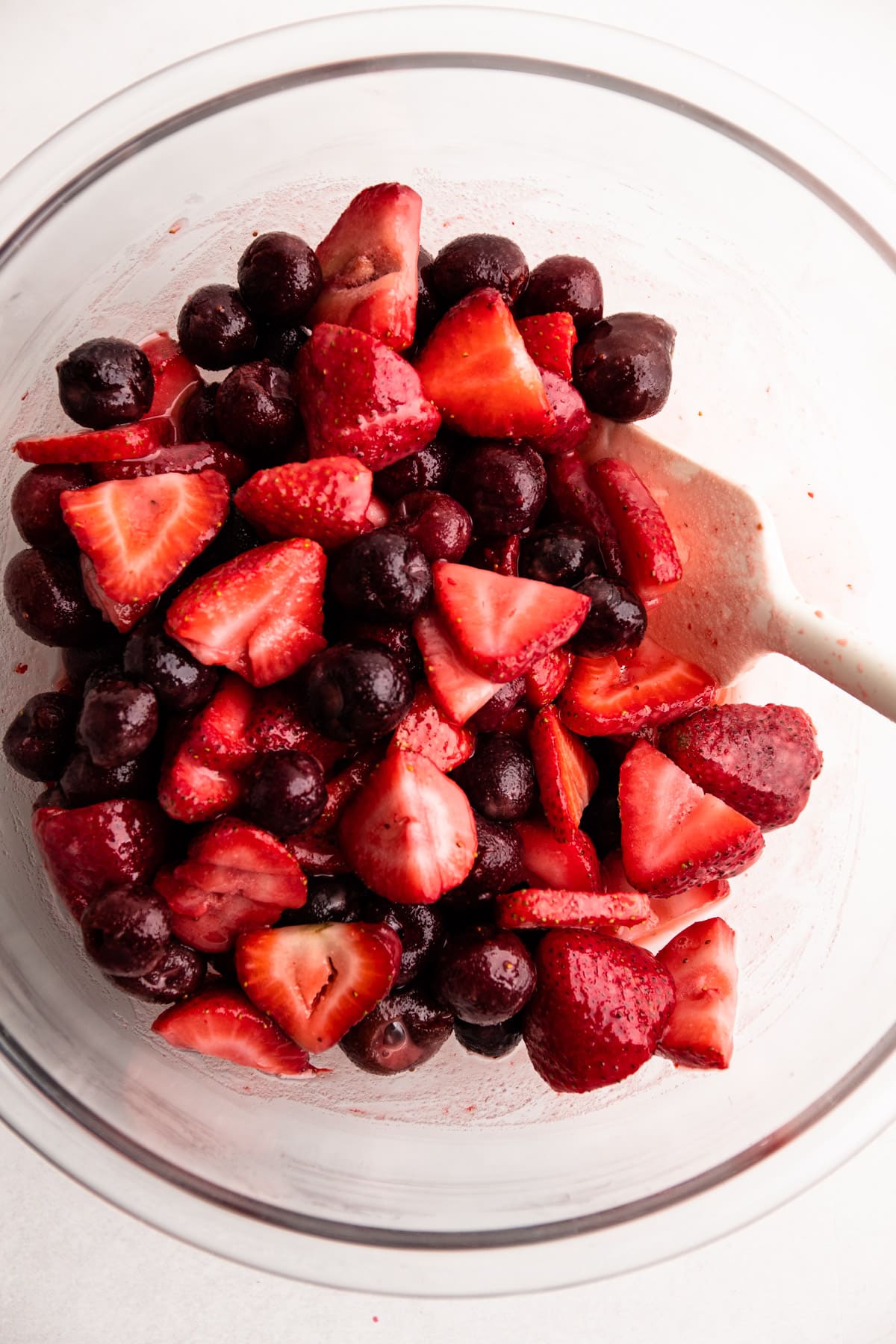 A bowl of strawberry cherry filling.