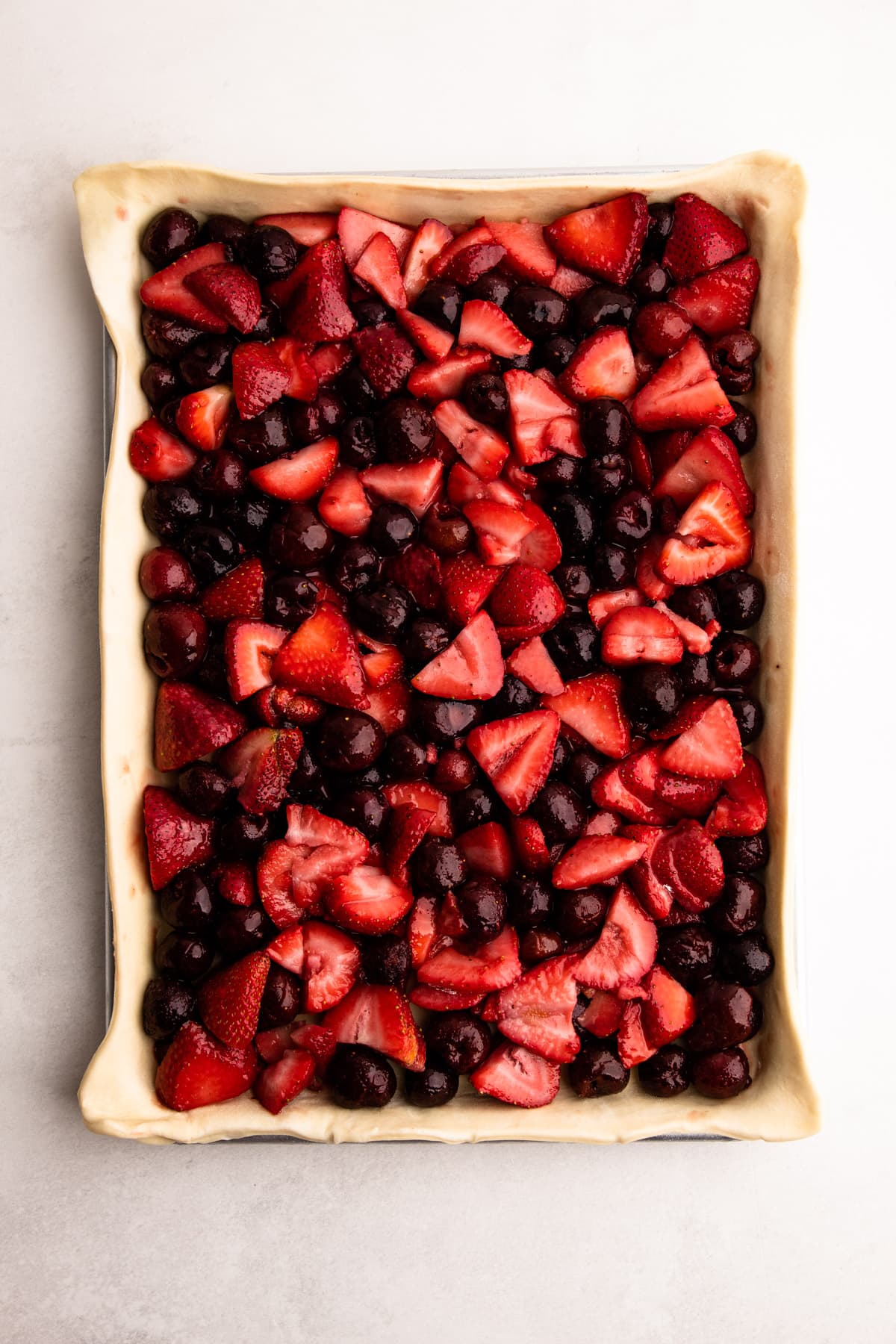 A strawberry cherry slab pie unbaked.