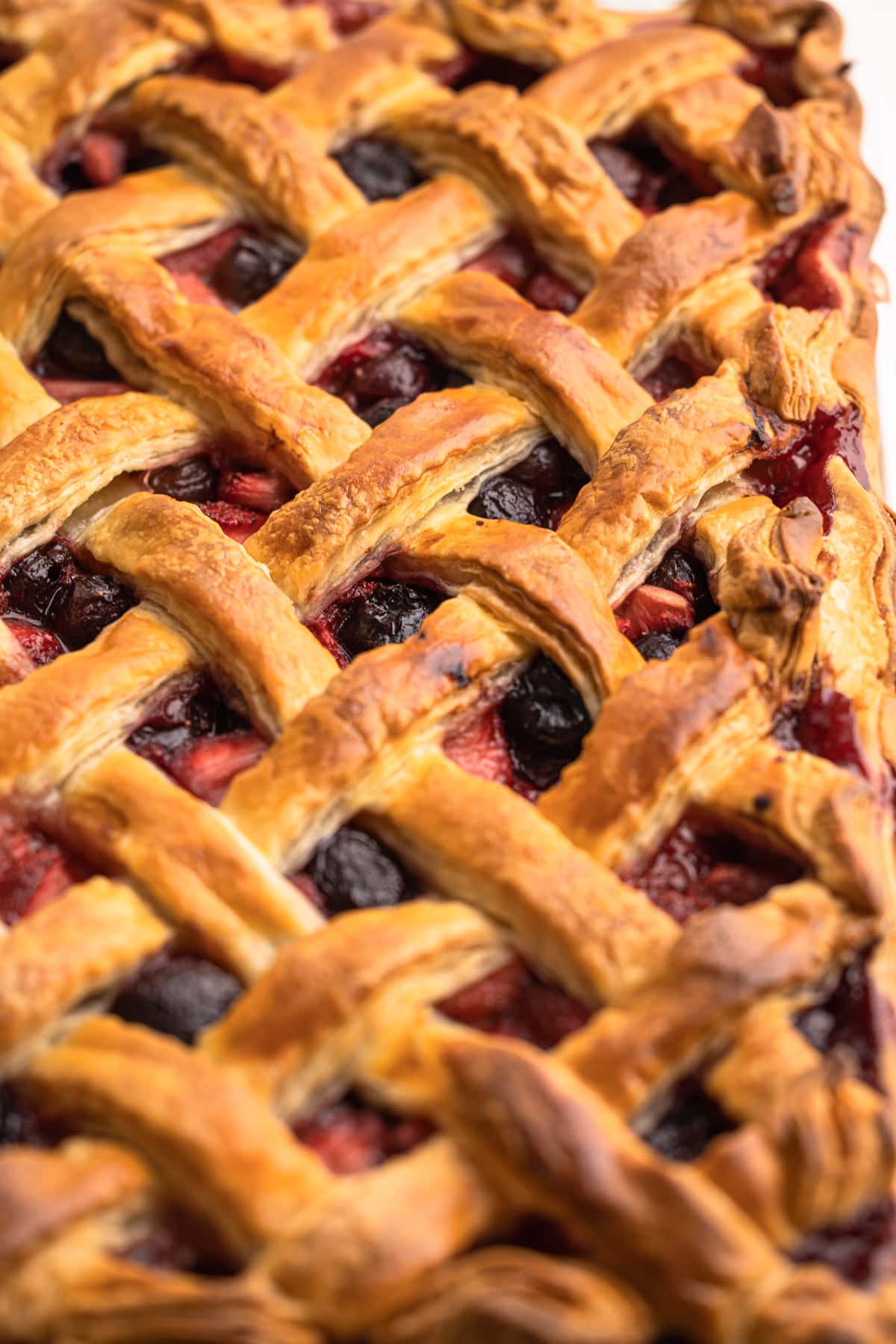 A baked cherry strawberry slab pie.