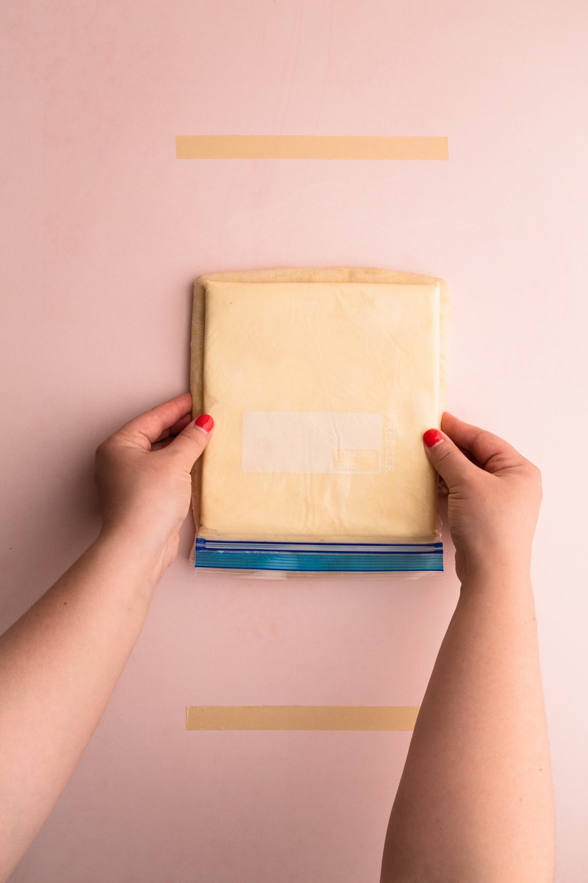 Putting the butter block on top of the dough to see that they match up.