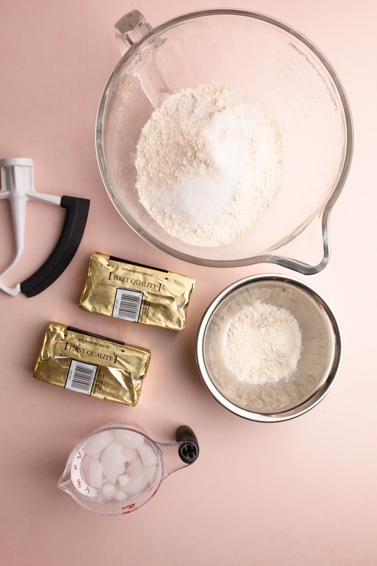 Ingredients for full puff pastry on a pink surface.
