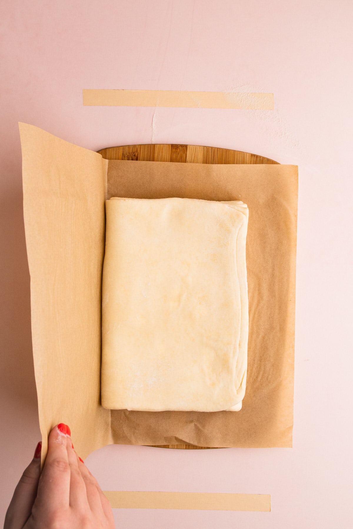 Puff pastry resting on a cutting board.