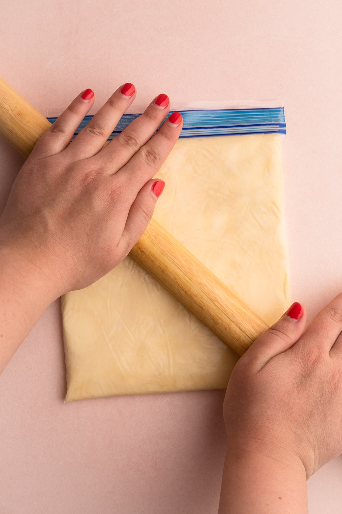 Putting the butter inside of a plastic bag to help shape the butter block.