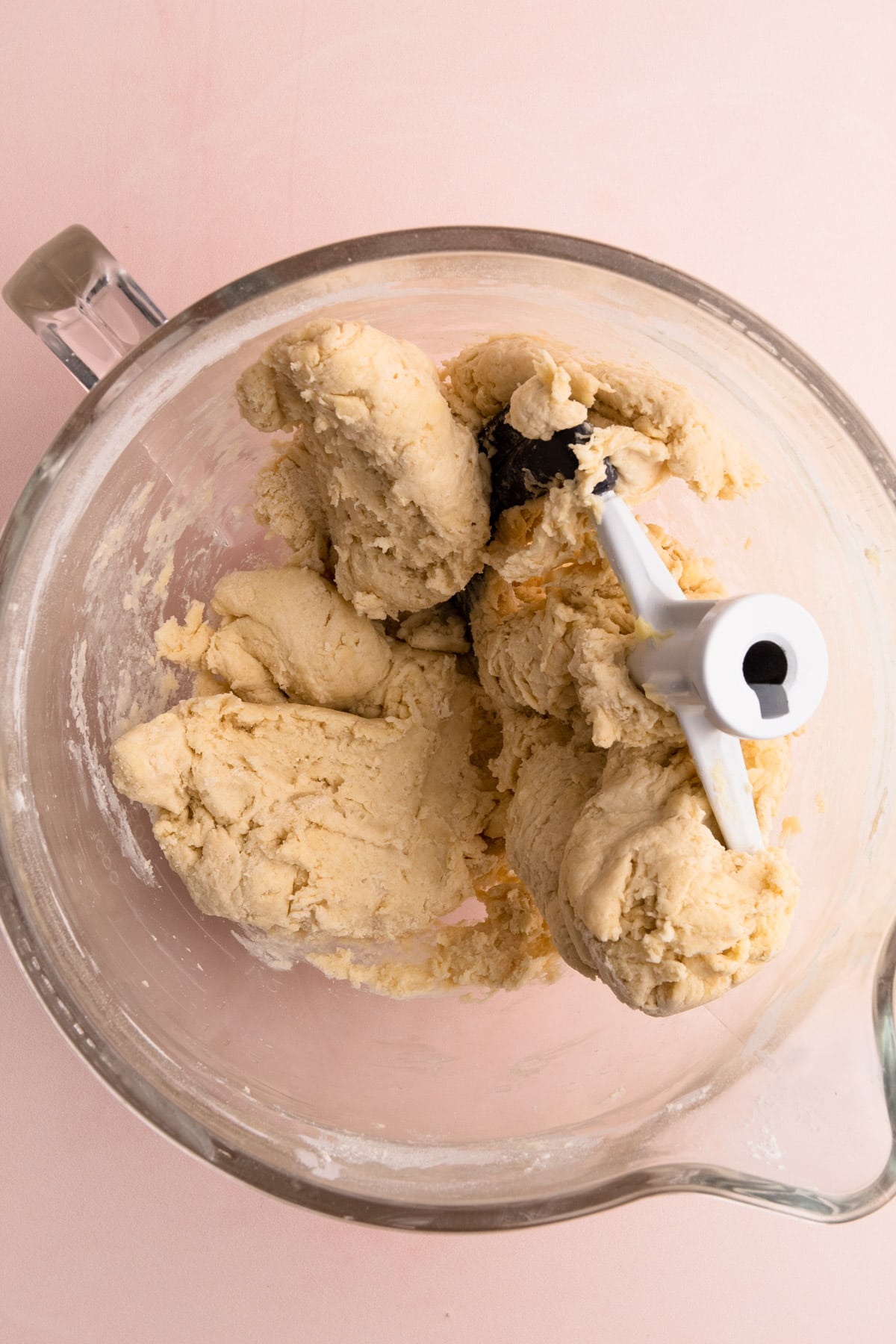 Making the detramp in a stand mixer on a pink background.