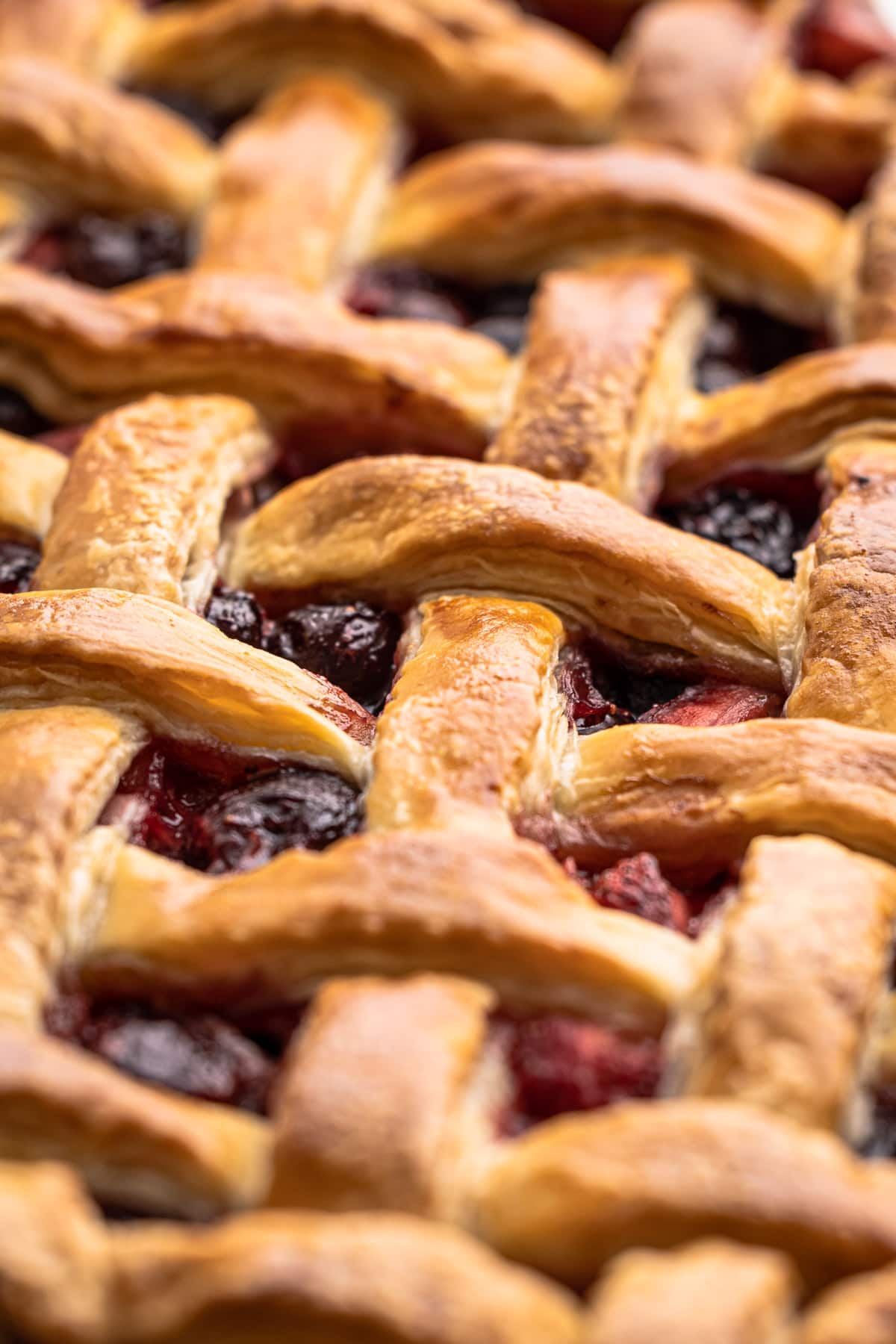 A baked cherry pie with butter pie crust.