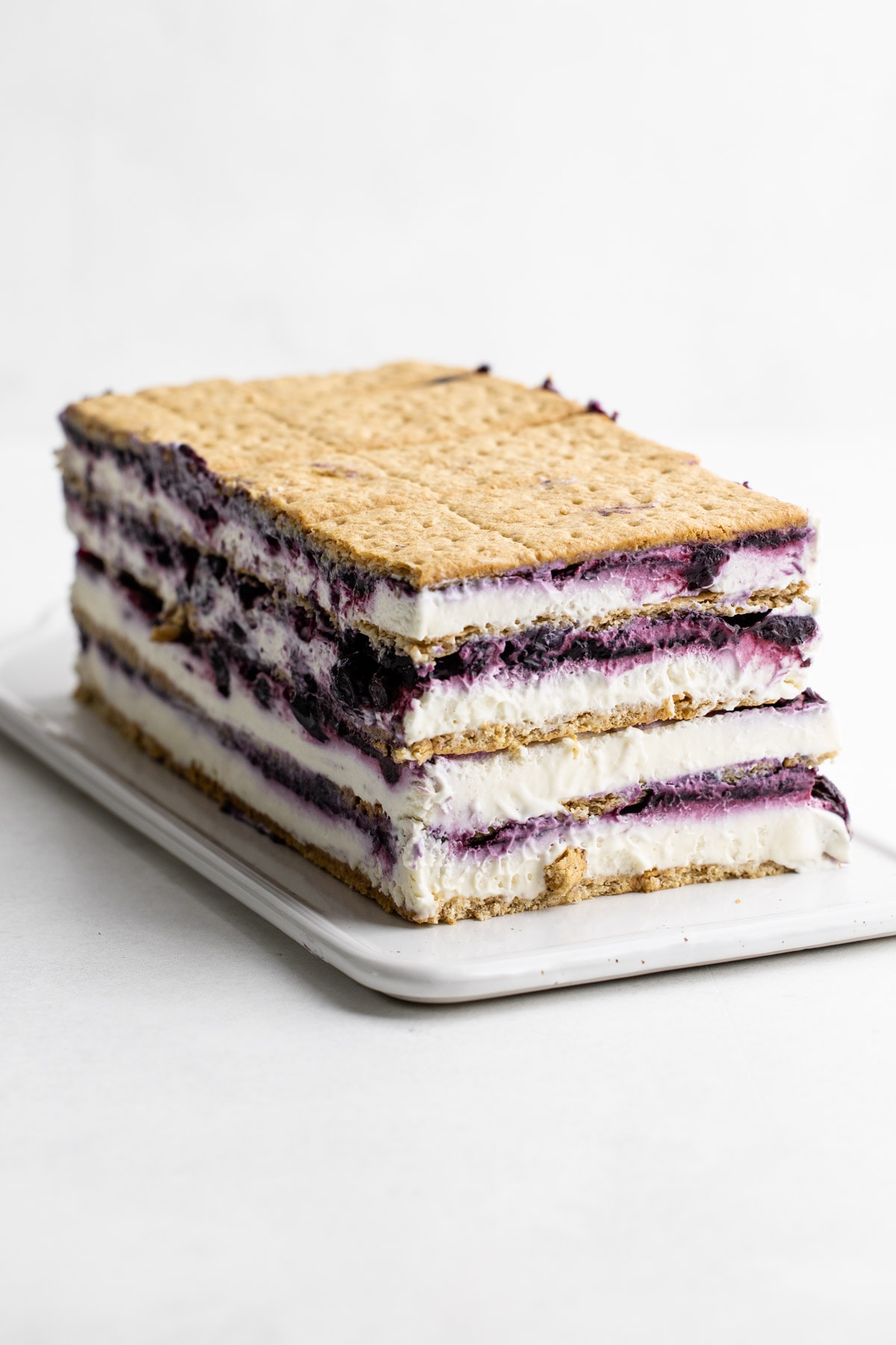 A blueberry icebox cake stacked on a platter.