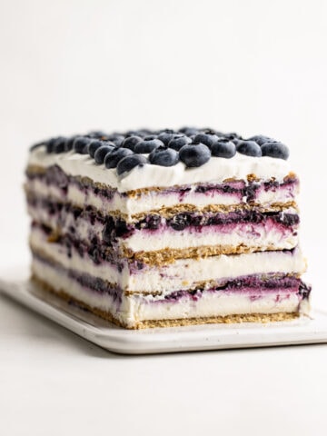 Blueberry Icebox Cake decorated with blueberries and revealed layers.