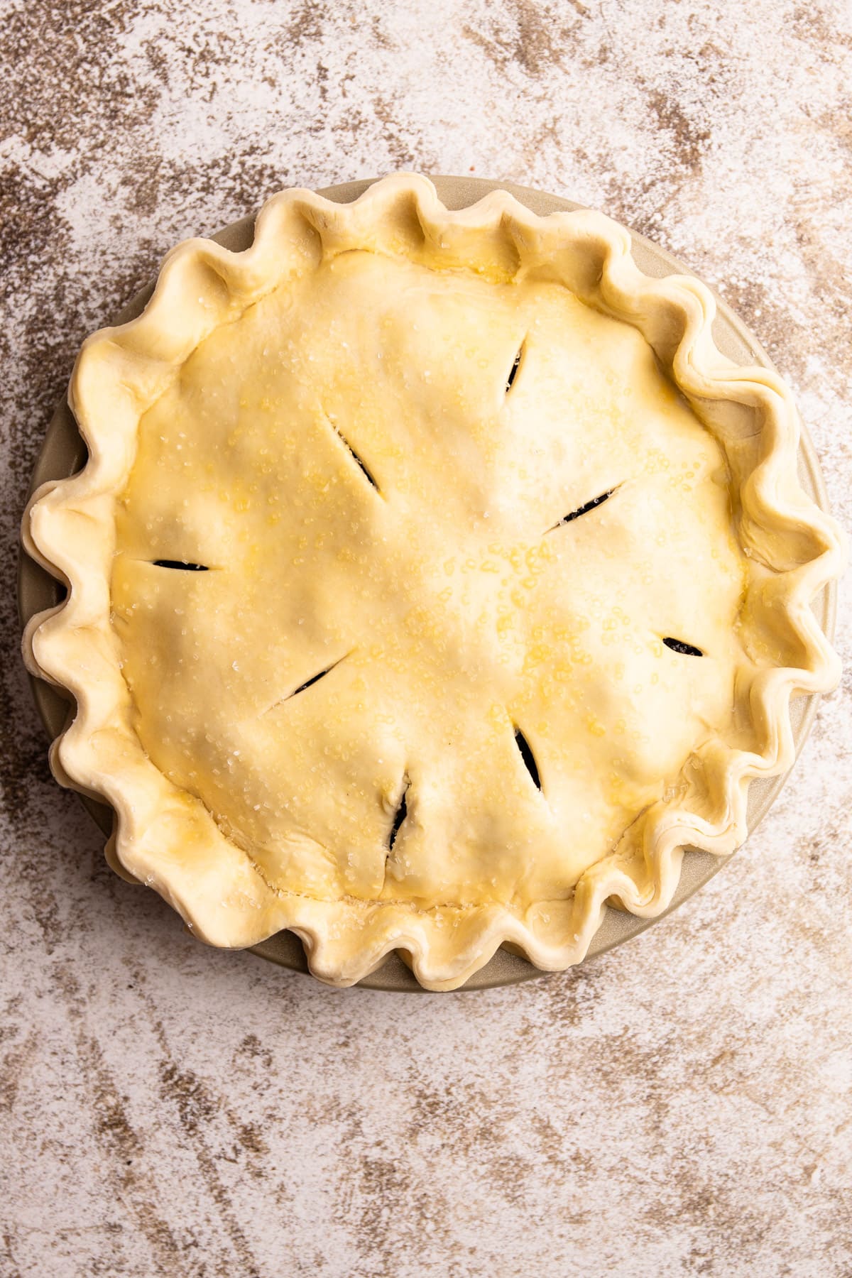 An assembled and unbaked blackberry pie.