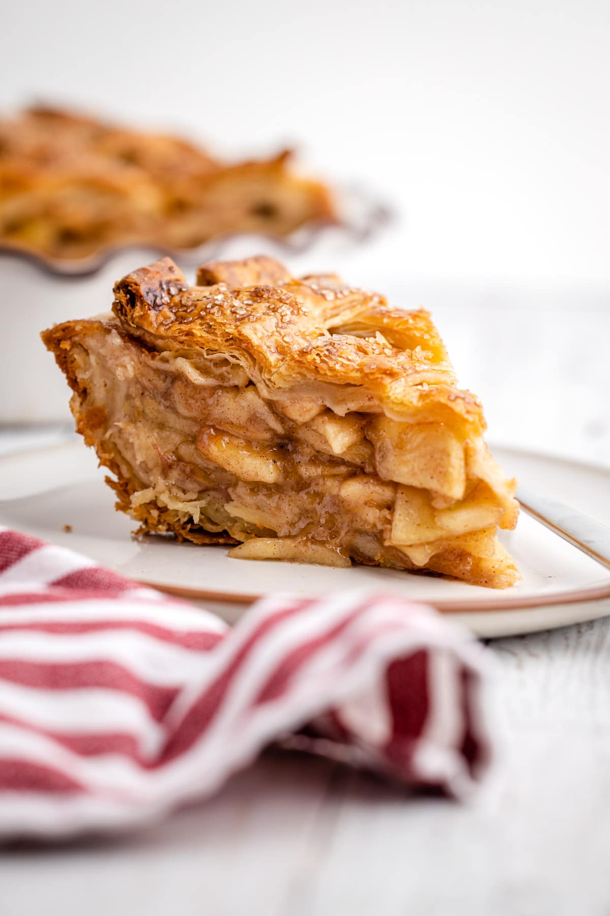 A slice of apple pie with flaky crust,