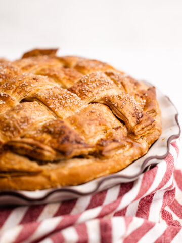 An apple pie made with a flaky pie crust.