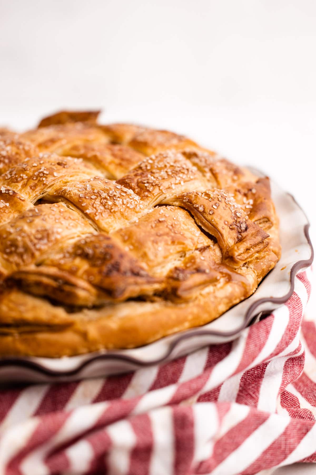 An apple pie made with a flaky pie crust.