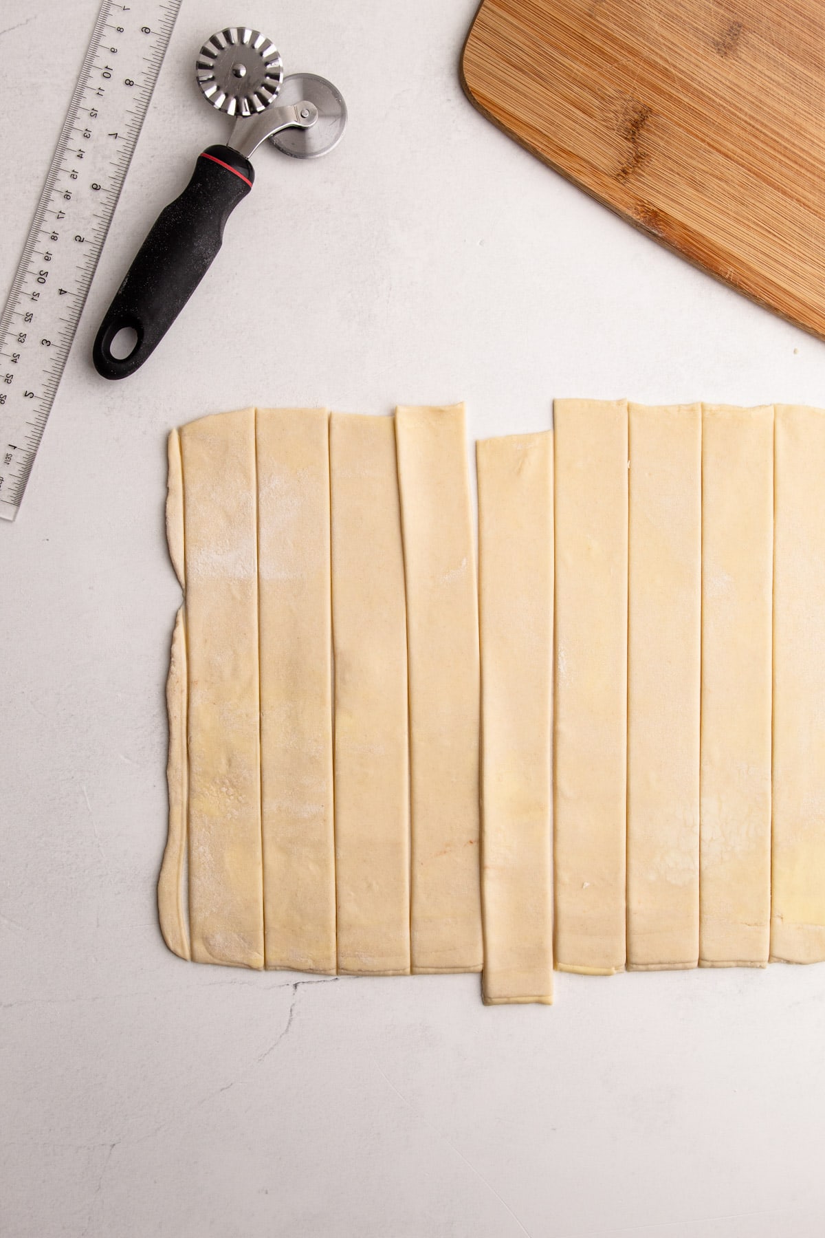 Strips of butter pie dough cut to make a lattice pie.