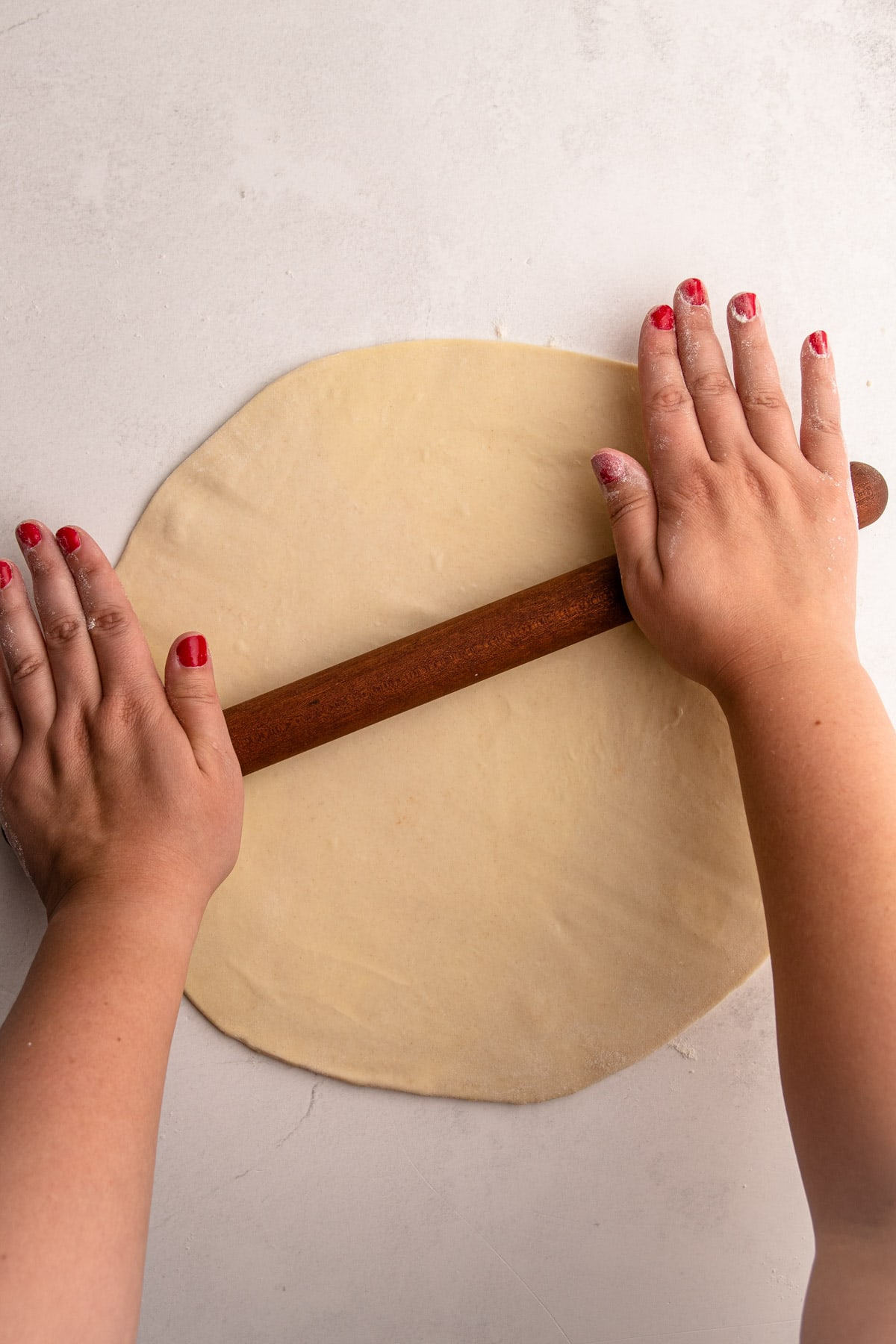 Rolling out flaky pie crust dough.