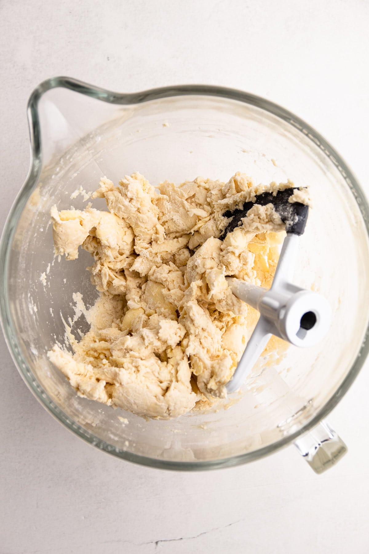 Flaky pie dough in a stand mixer.