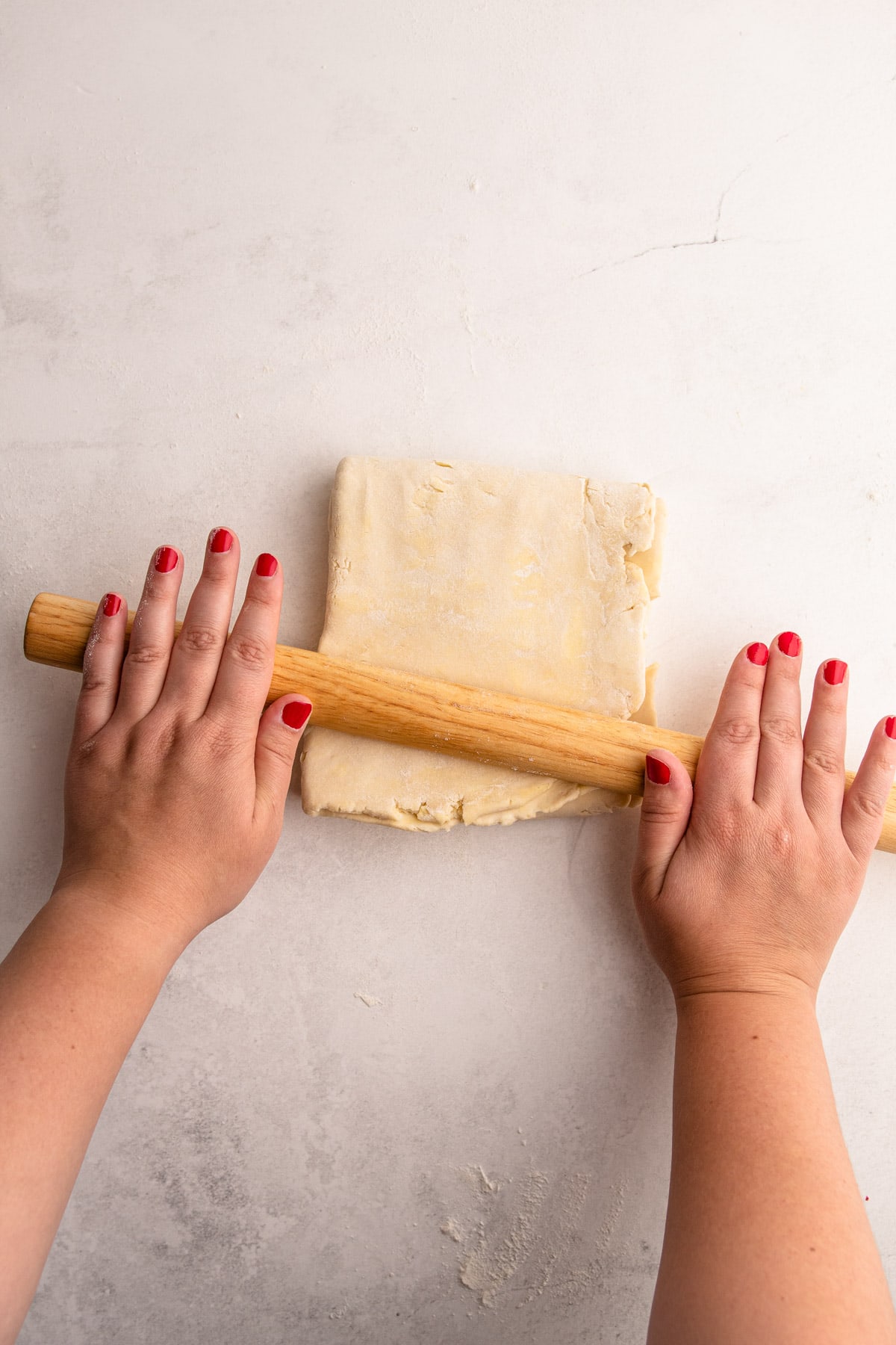 Rolling out the flaky dough.