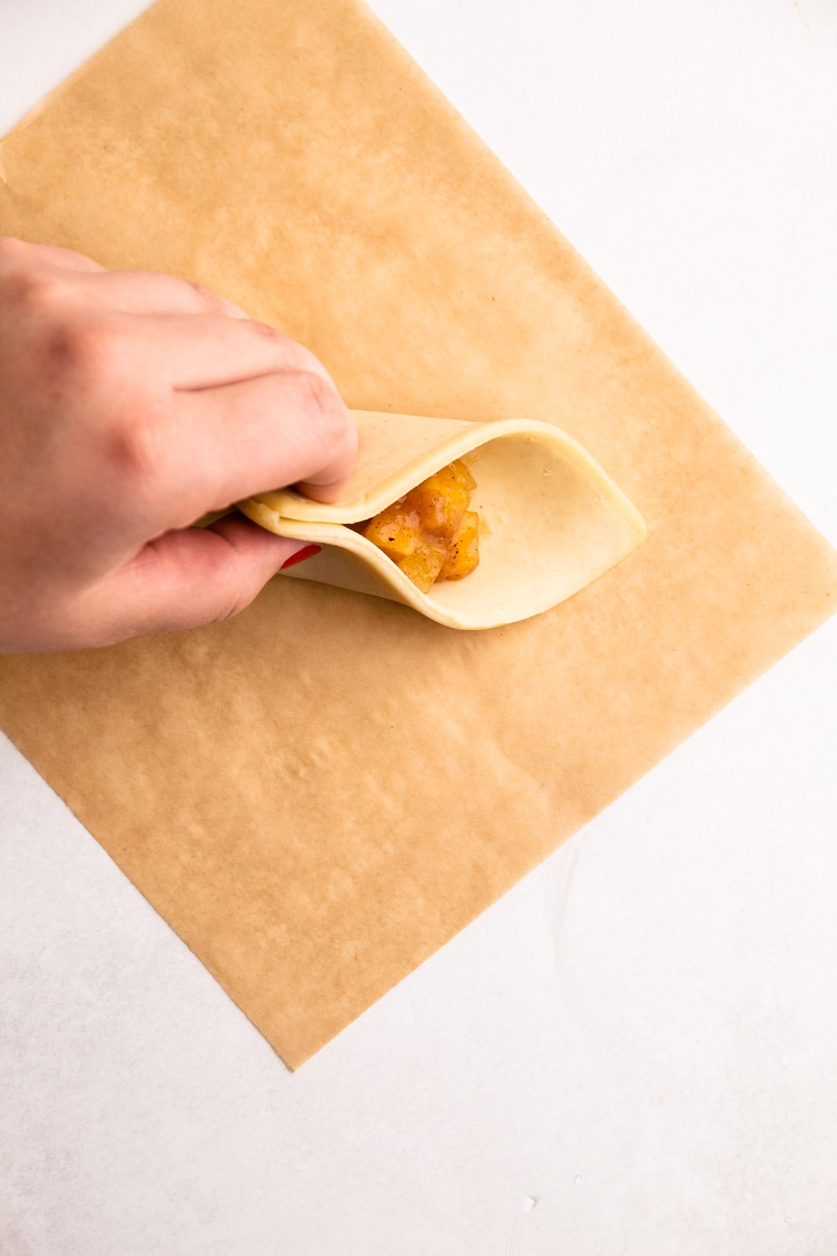 Preparing an apple turnover.