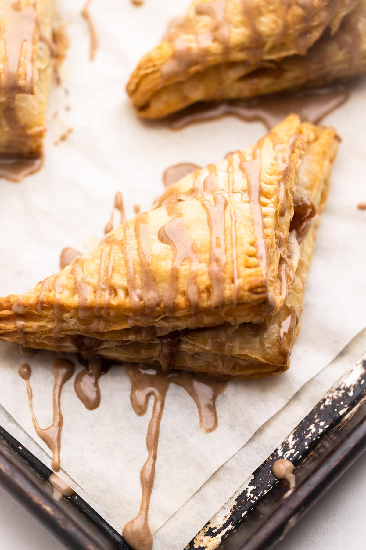 Apple turnovers on a sheet tray.