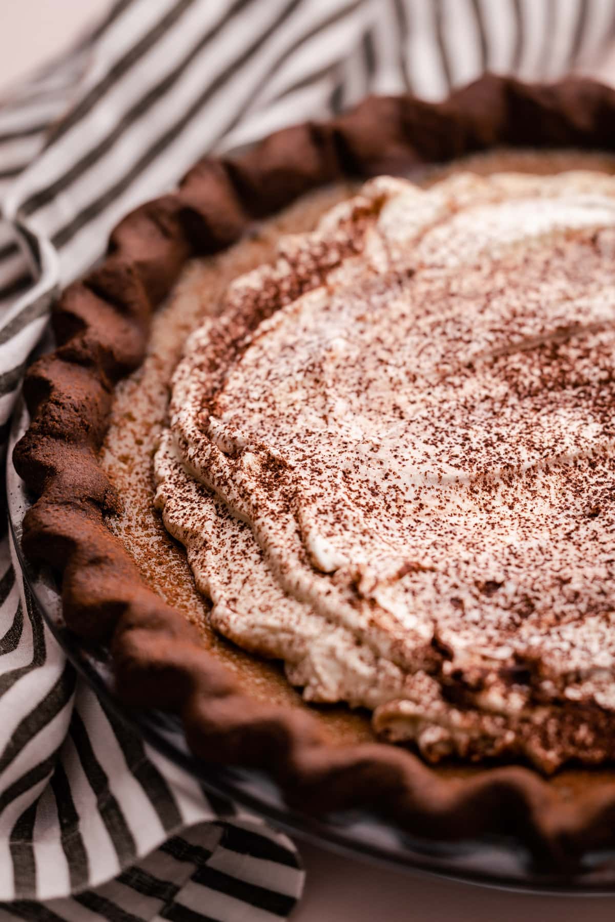A coffee custard pie with whipped cream on top.