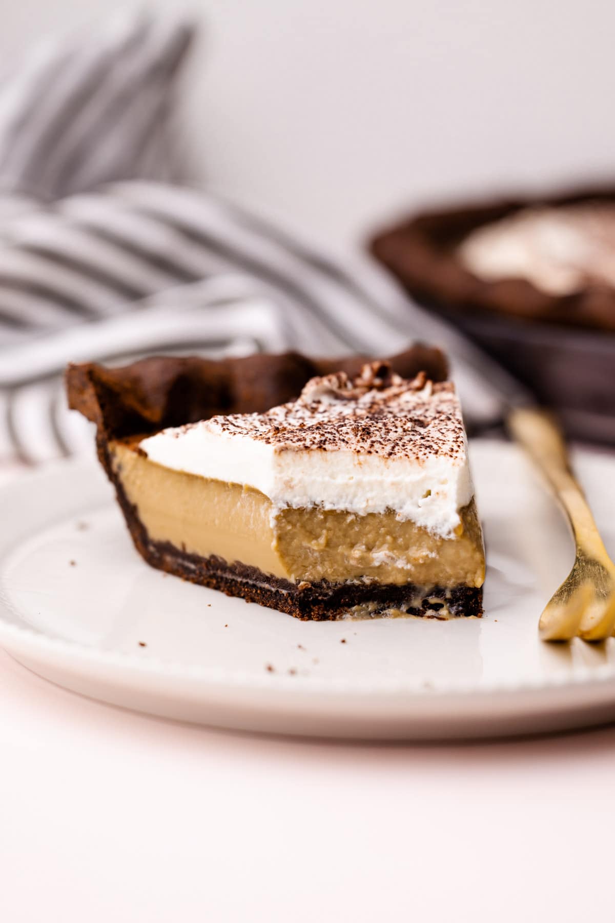 A slice of coffee custard pie with a chocolate pie crust.