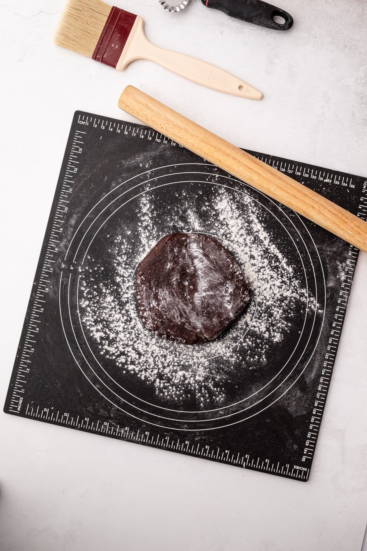 Rolling out chocolate pie crust.